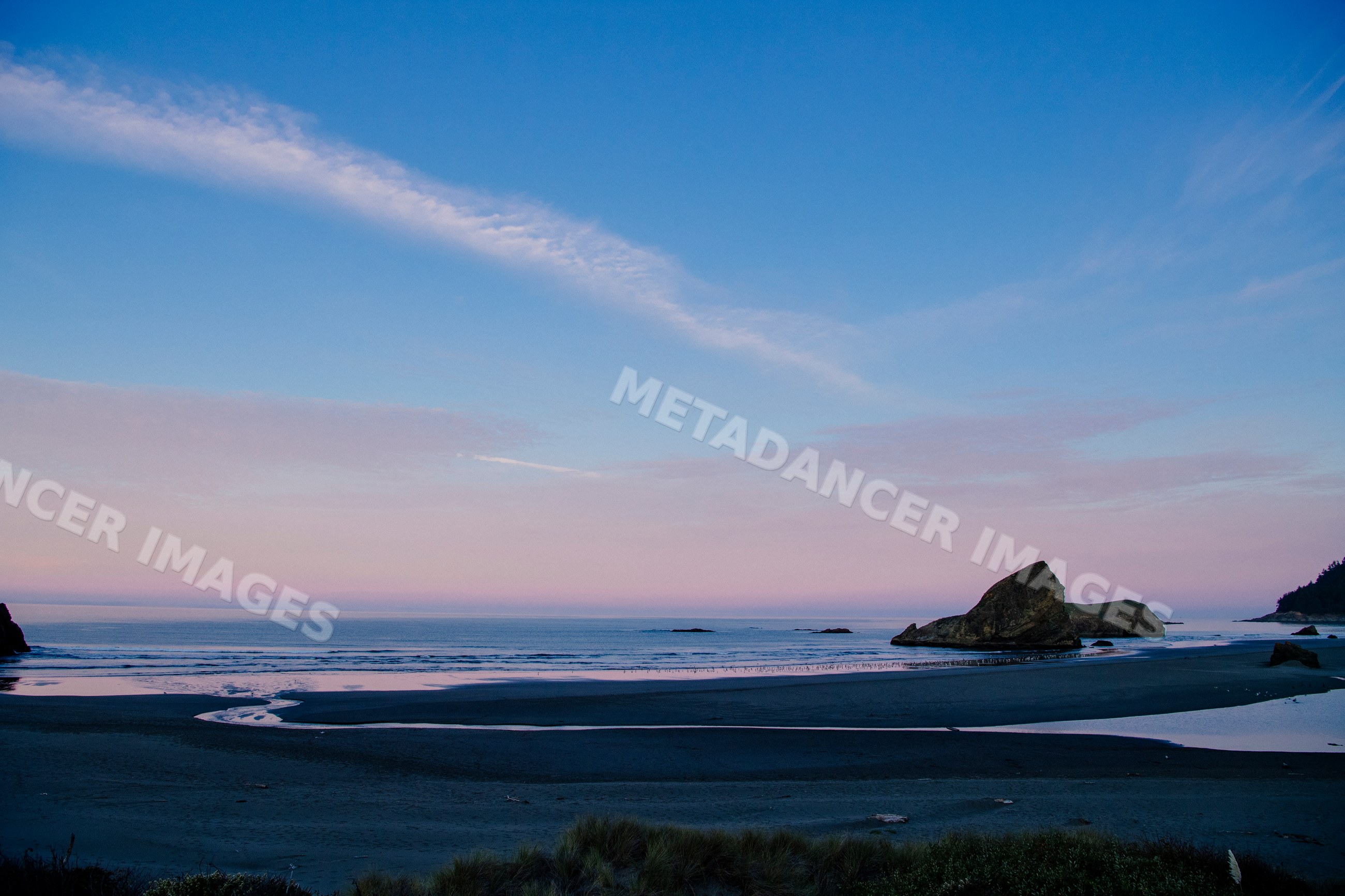 Rock formations along calm beach at sunset near meyers creek Oregon