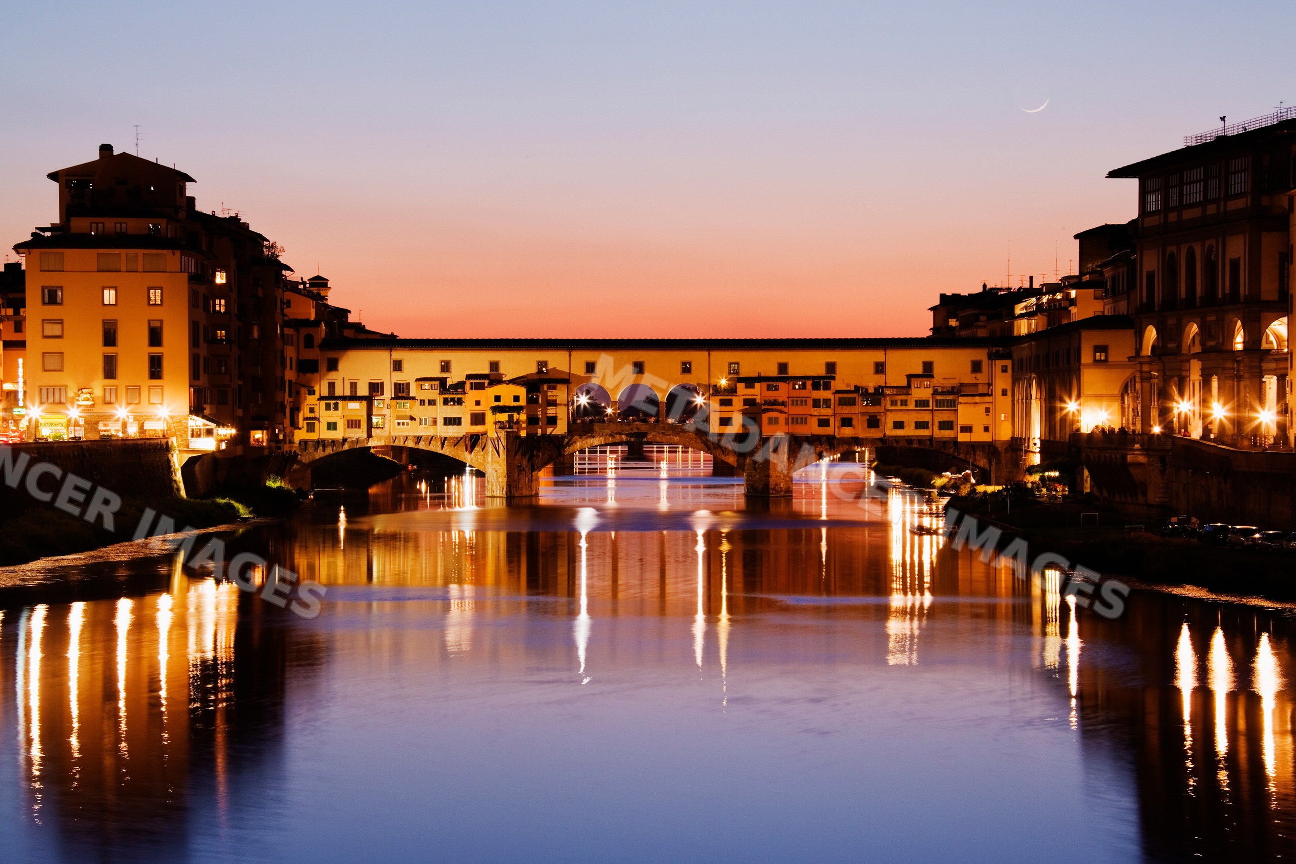 Ponte vecchio bridge over arno river at sunset italy