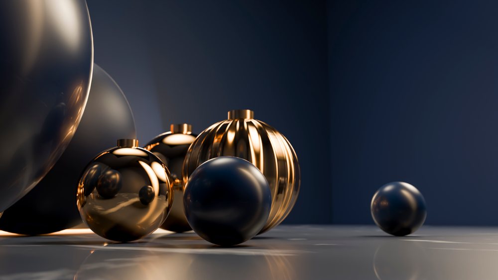 Decorative metallic black and gold spheres on reflective surface