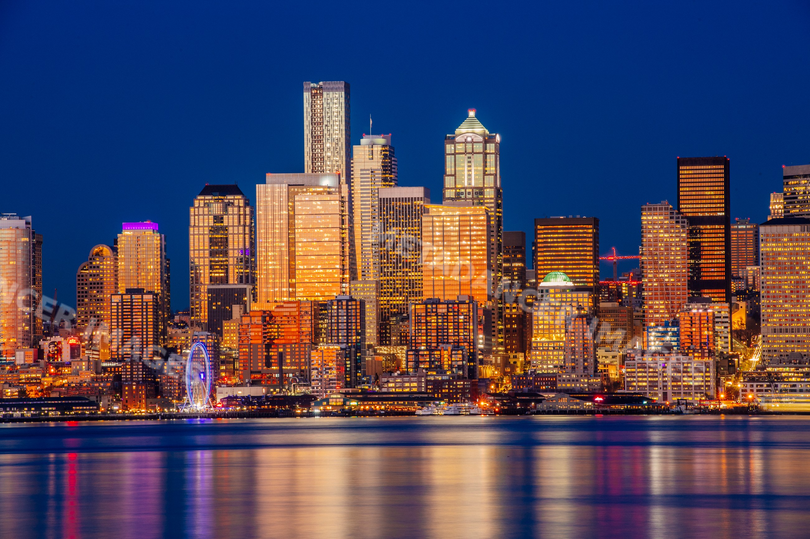 Seattle skyline at night with illuminated skyscrapers and waterfront
