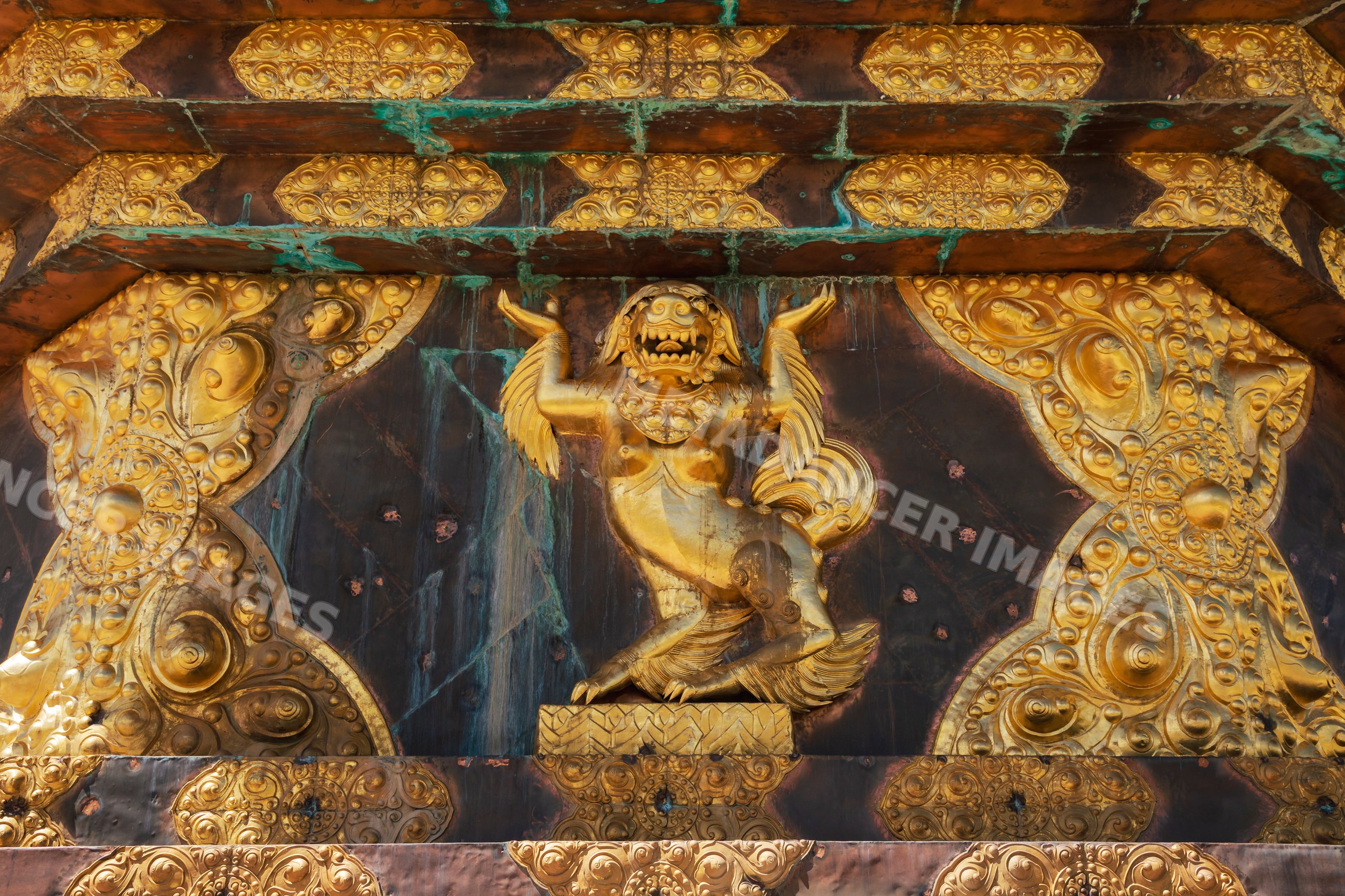 Detail of the ornate golden mythical creature carving