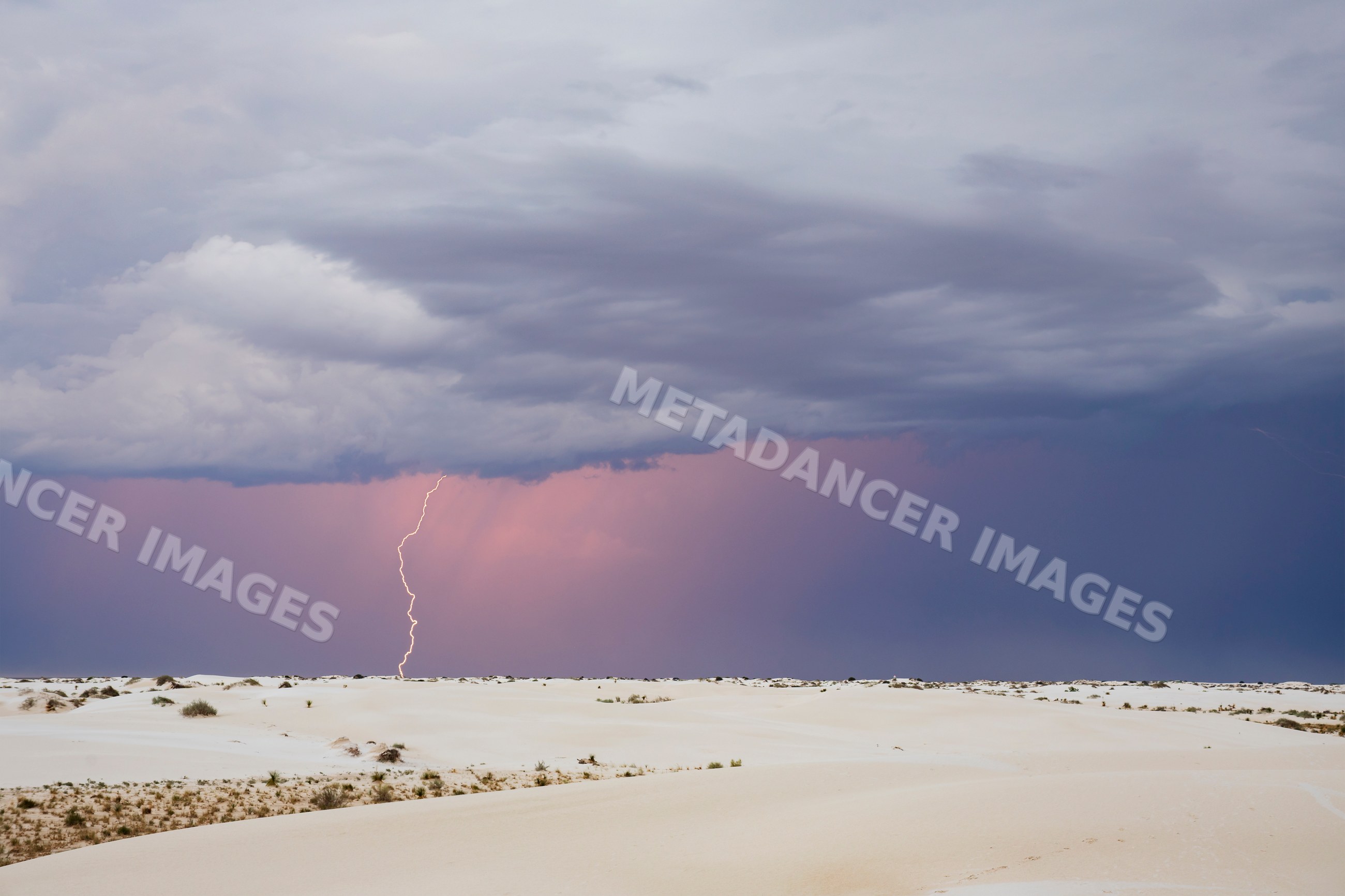 Lightning strike over sand dunes in a park