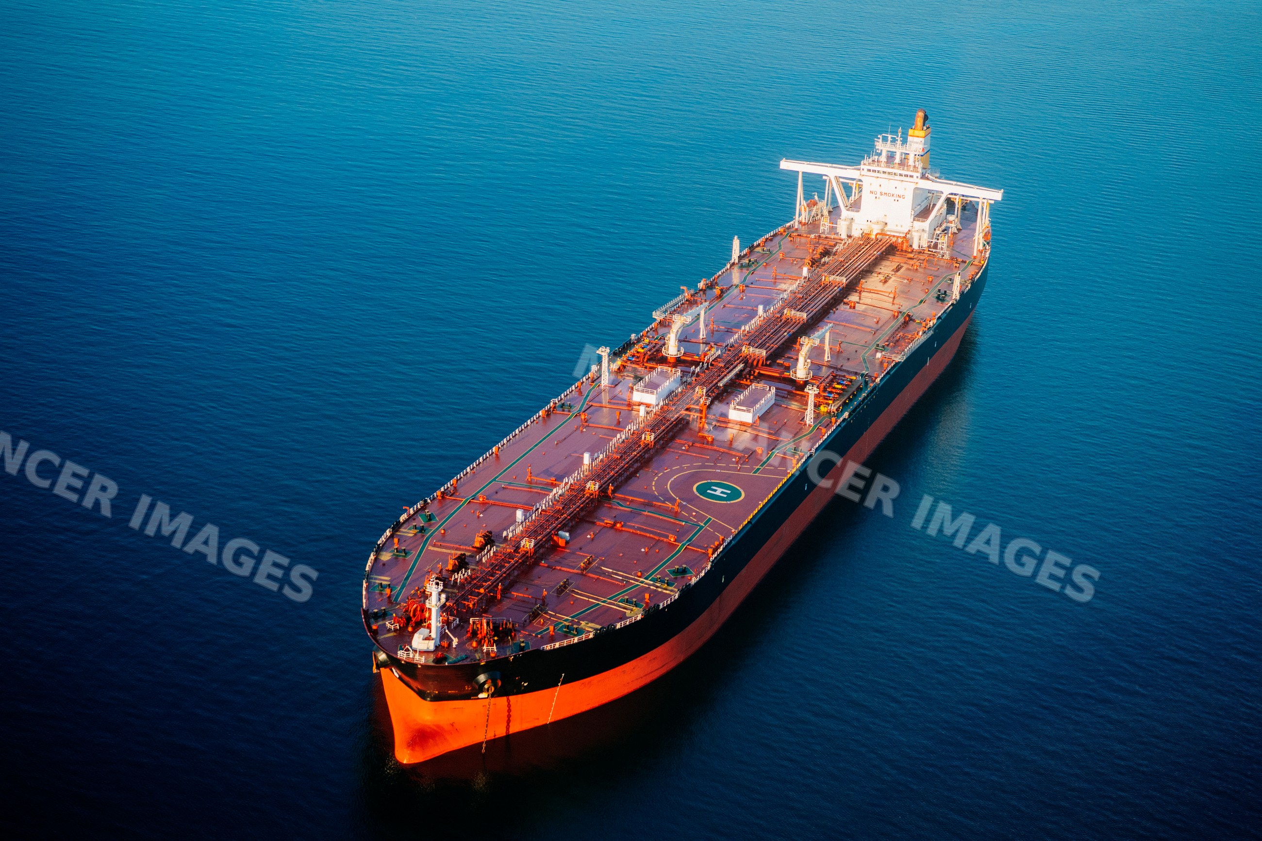 Oil tanker floating on ocean in a beach
