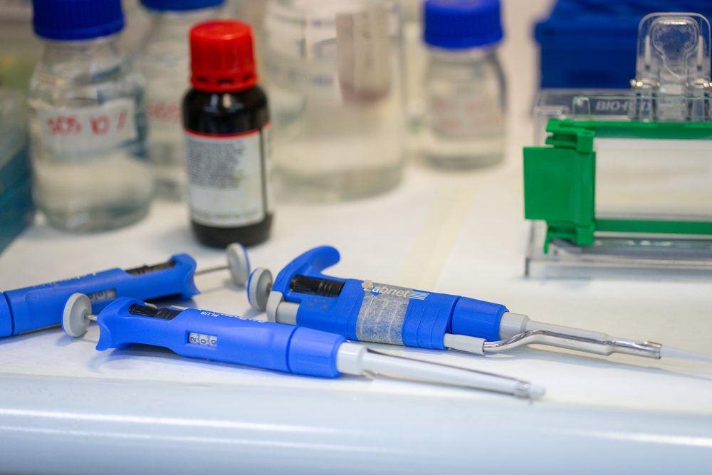 Laboratory pipettes and bottles on laboratory bench in Seville
