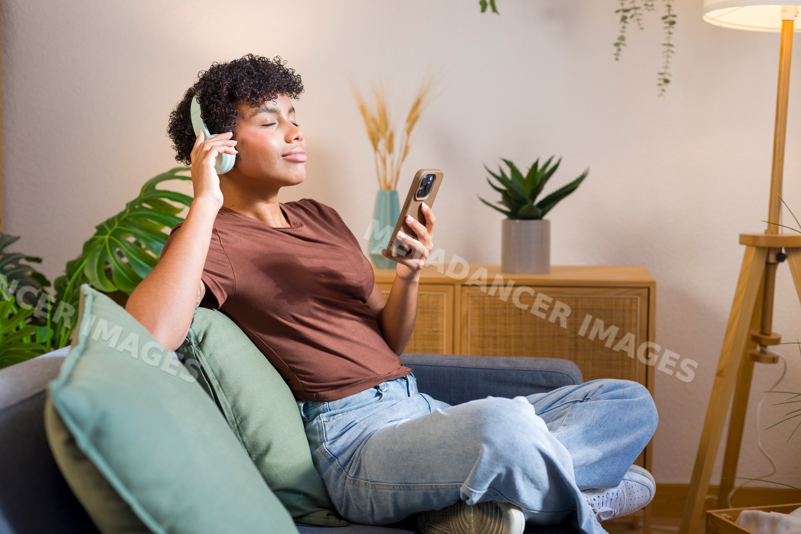 Young African American woman listening to music with headphones
