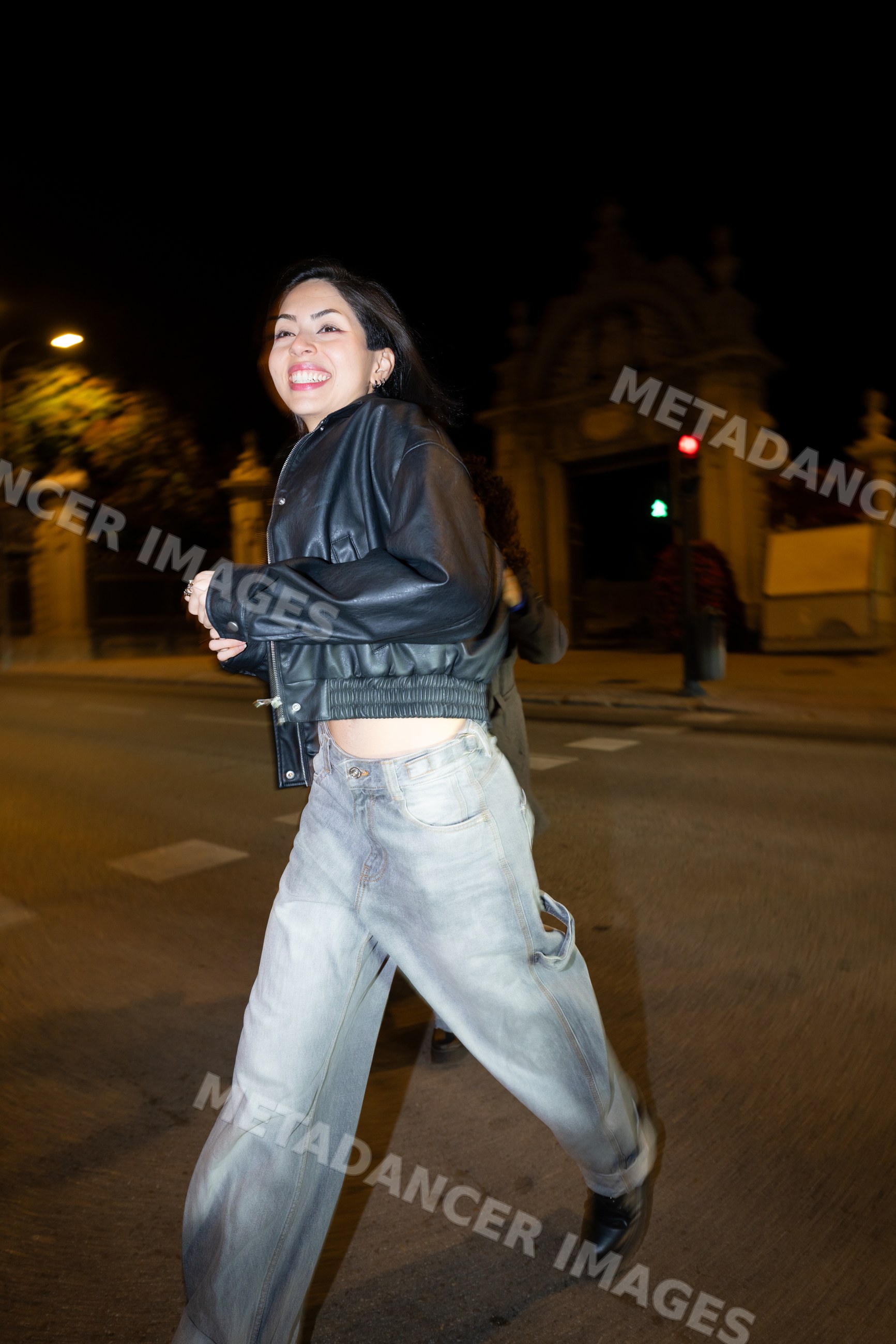 Hispanic woman running joyfully on city street