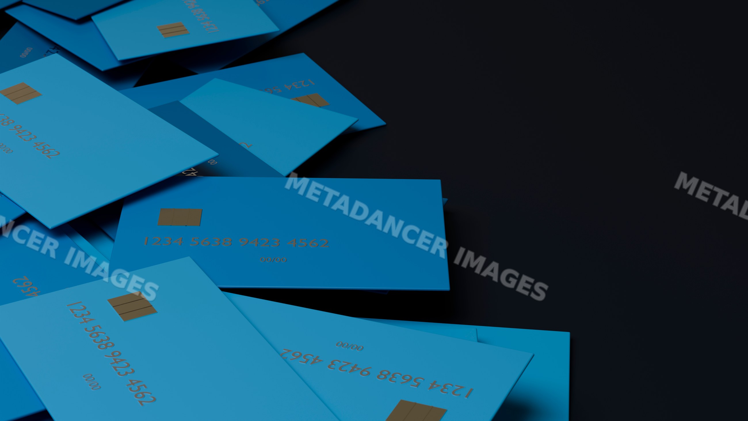 Stack of blue credit cards with chip on dark surface