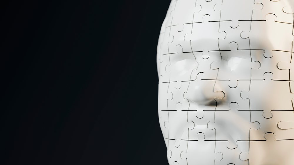 White human face made of jigsaw puzzle pieces conceptual illustration