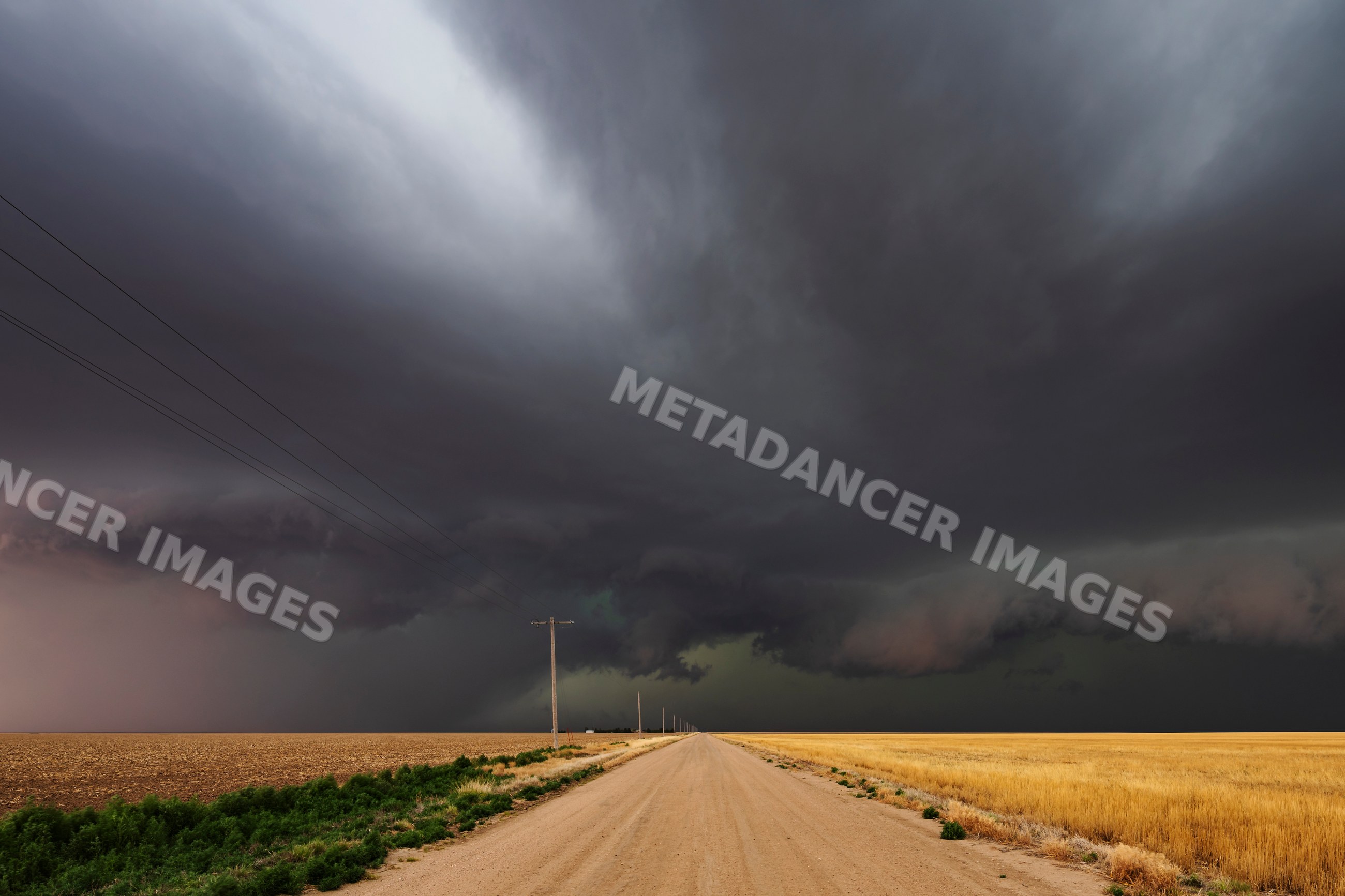 Developing Supercell storm over county dirt road in tribune, kansas