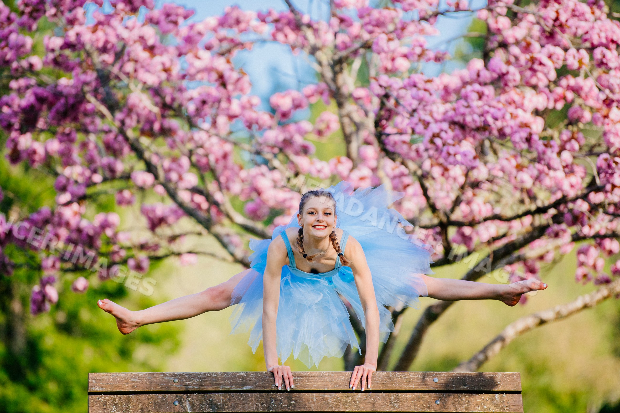 Ballet white dancer leaps over bench