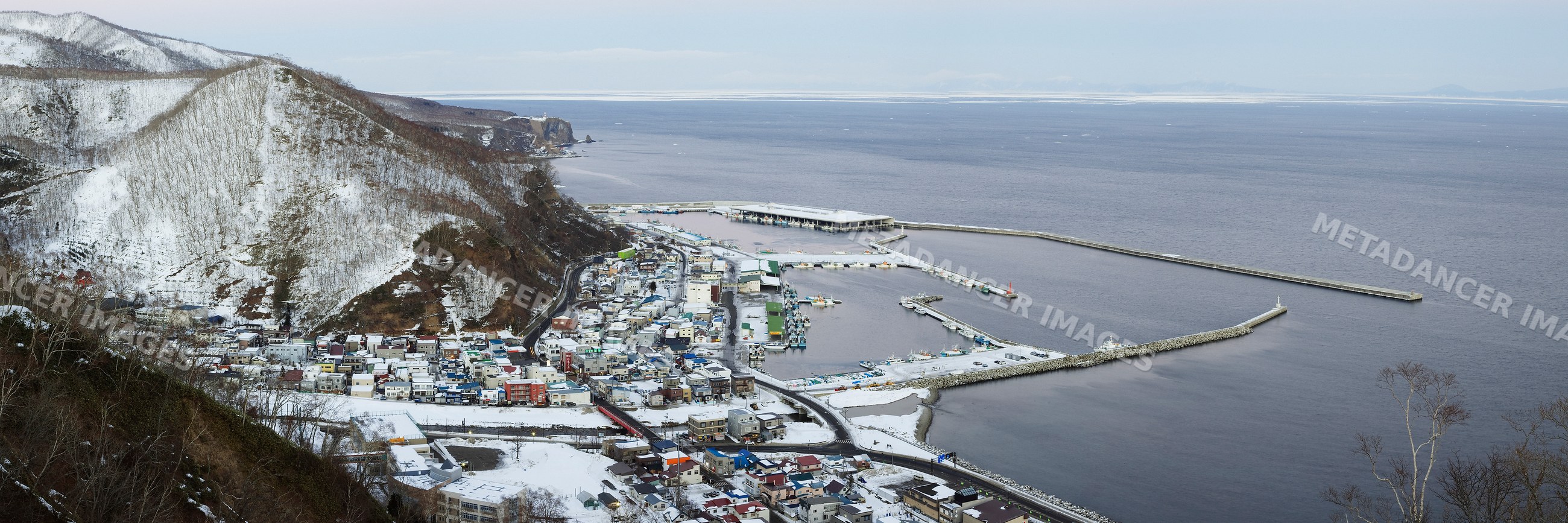 Fishing port and snowy coastal town, hokkaido, japan