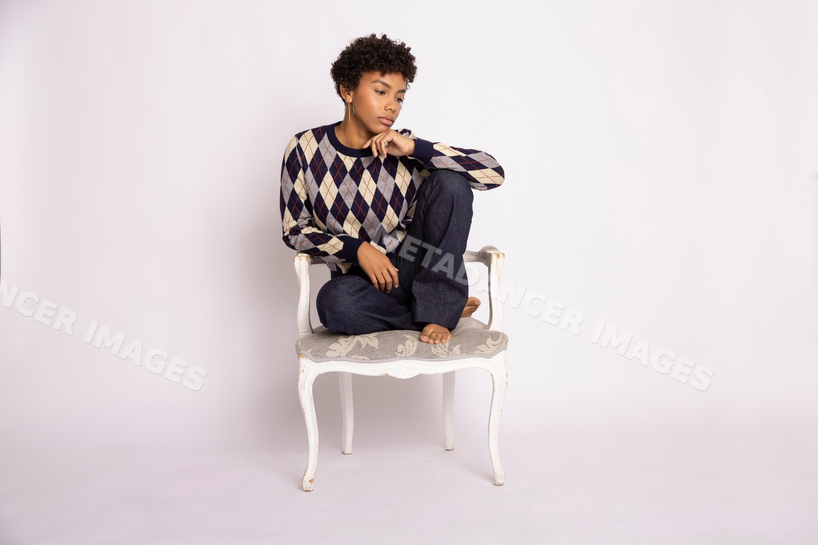 Young Hispanic woman sitting thoughtfully