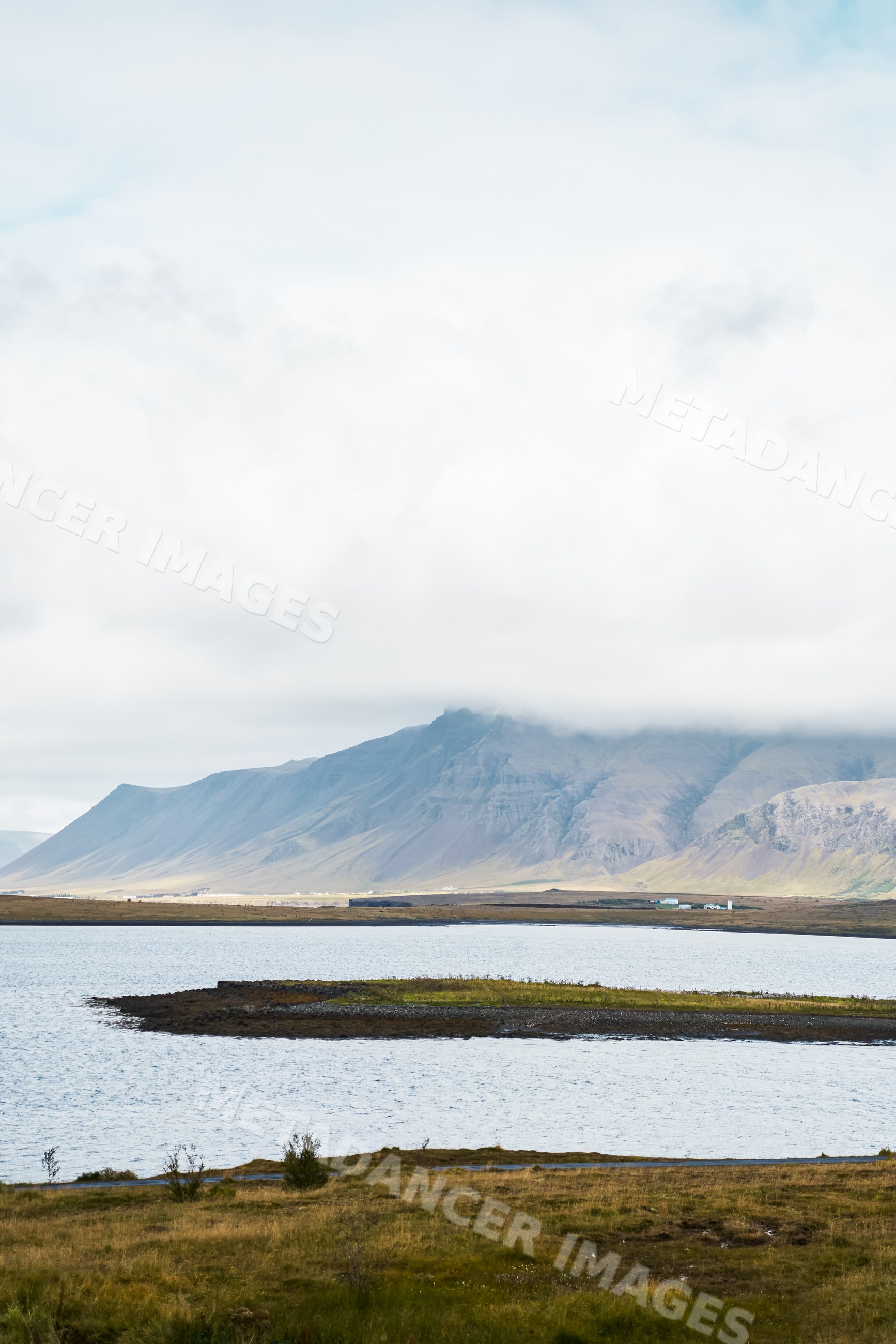 A serene lake and mountain landscape with clouds