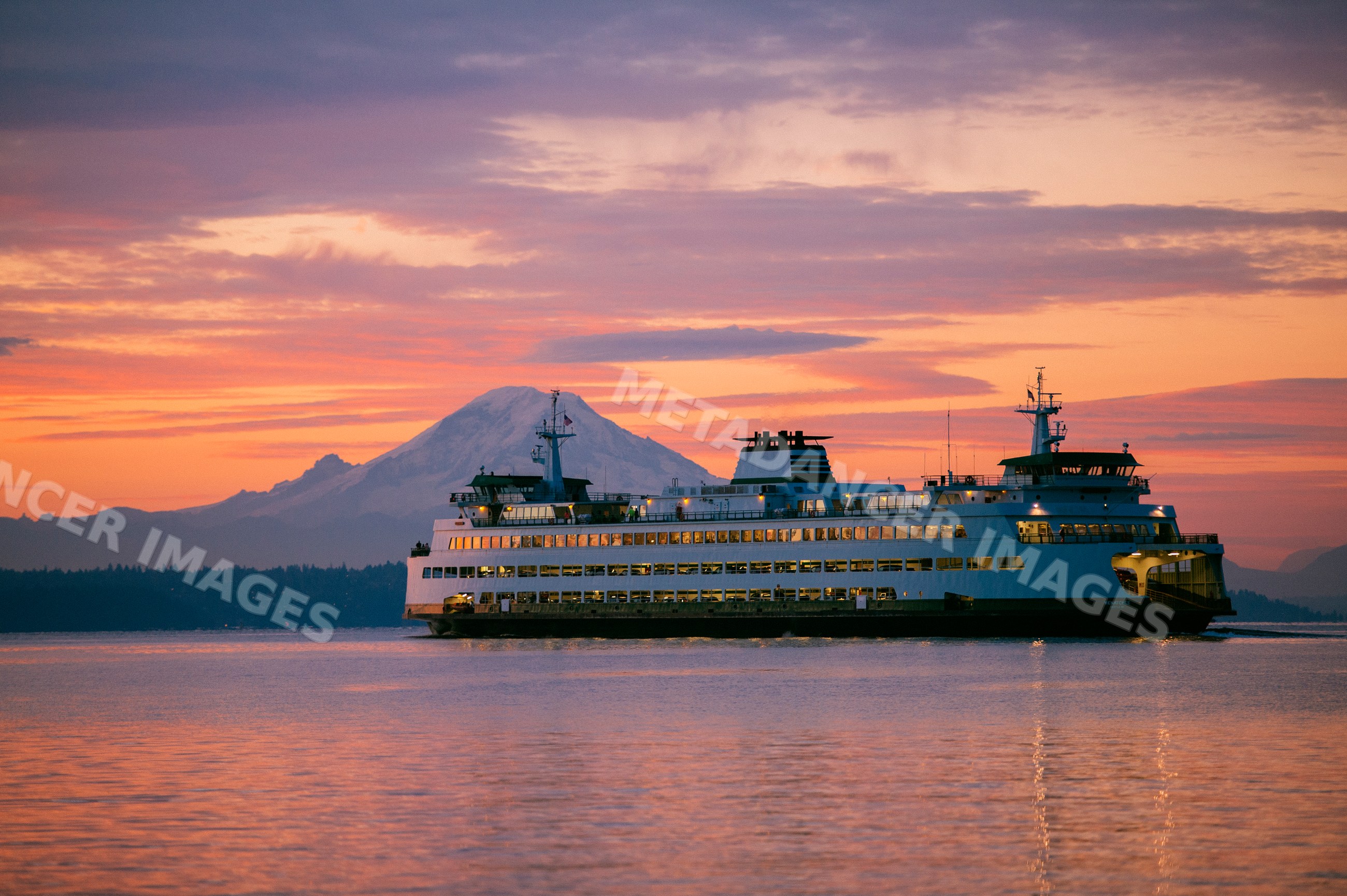 Seattle ferry crossing near Bainbridge Island at sunset with mount