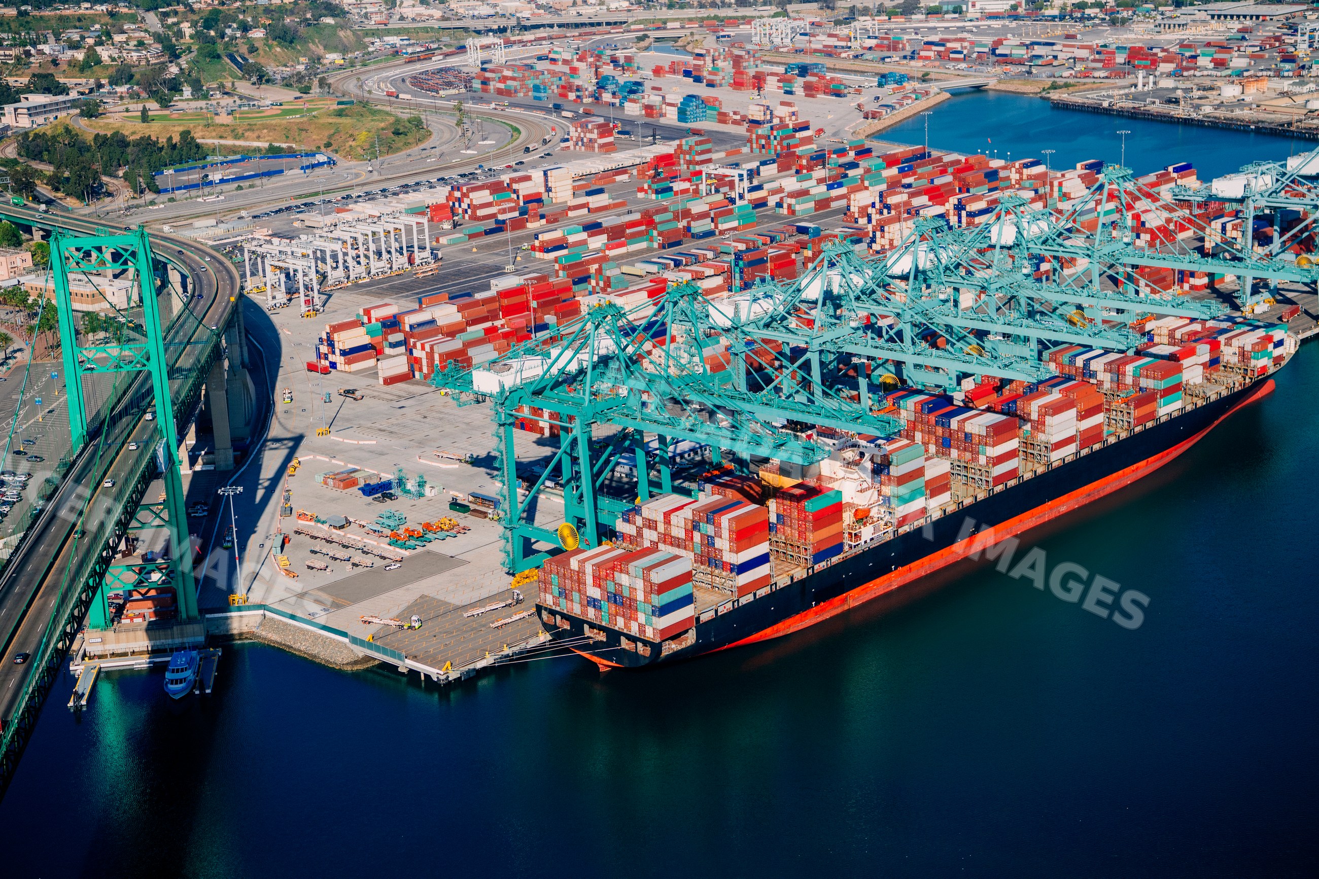 Container ship loaded with cargo at shipping terminal in a beach