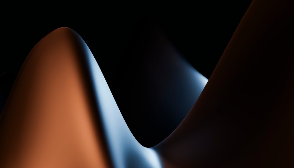 Abstract curved shapes illuminated with blue and orange lighting
