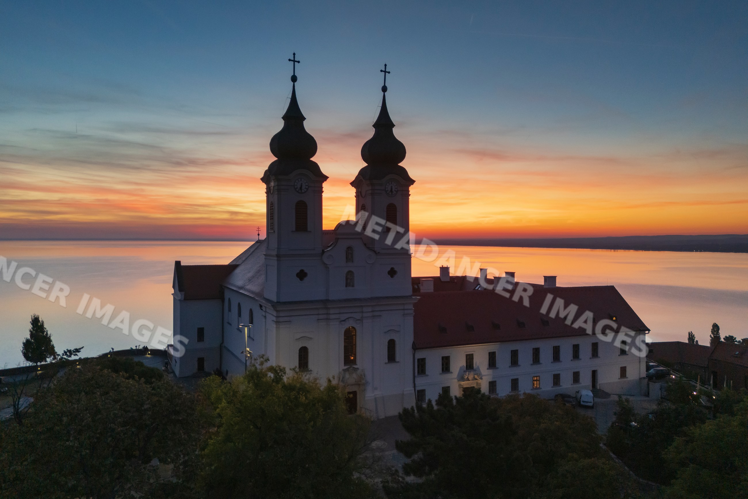 Benedictine Abbey of Tihany at sunset overlooking a lake