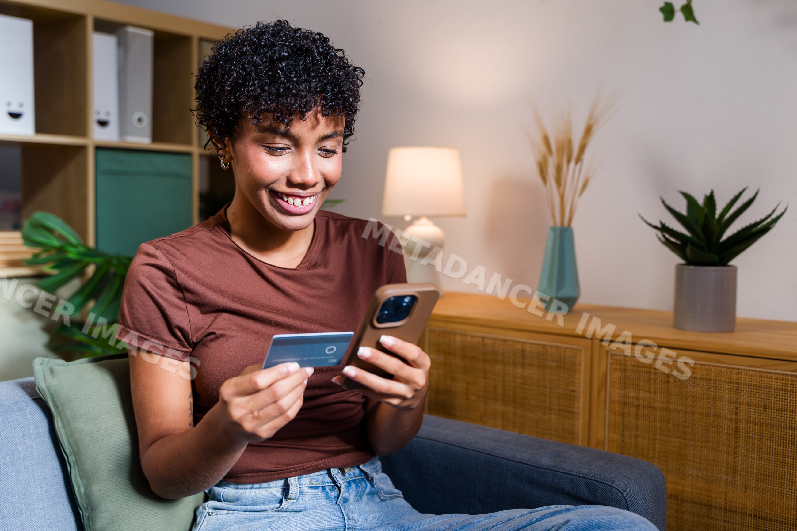 African American woman using smartphone and credit card