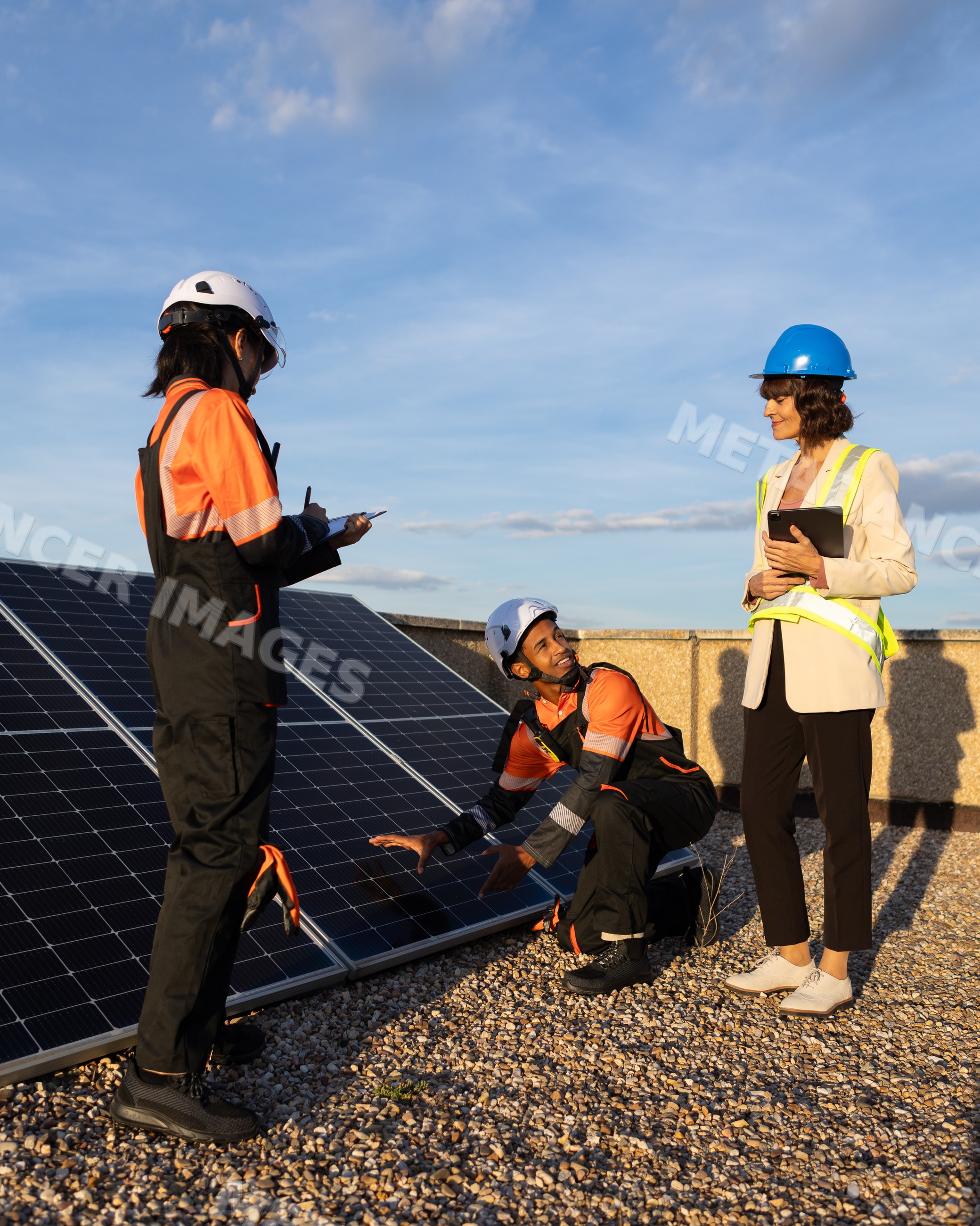 Technicians inspecting solar panels on rooftop in Madrid, Spain