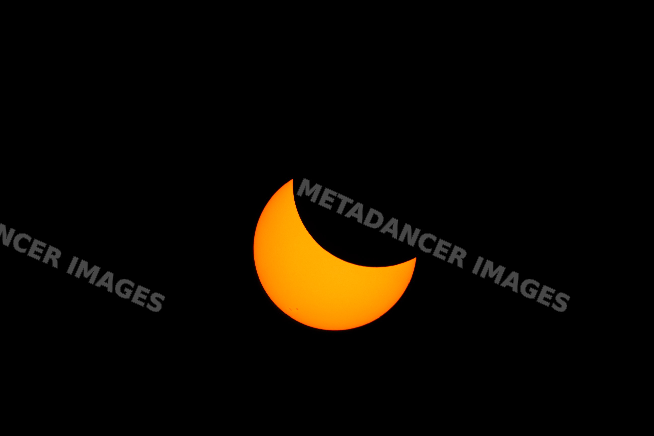 Partial solar eclipse with moon covering sun