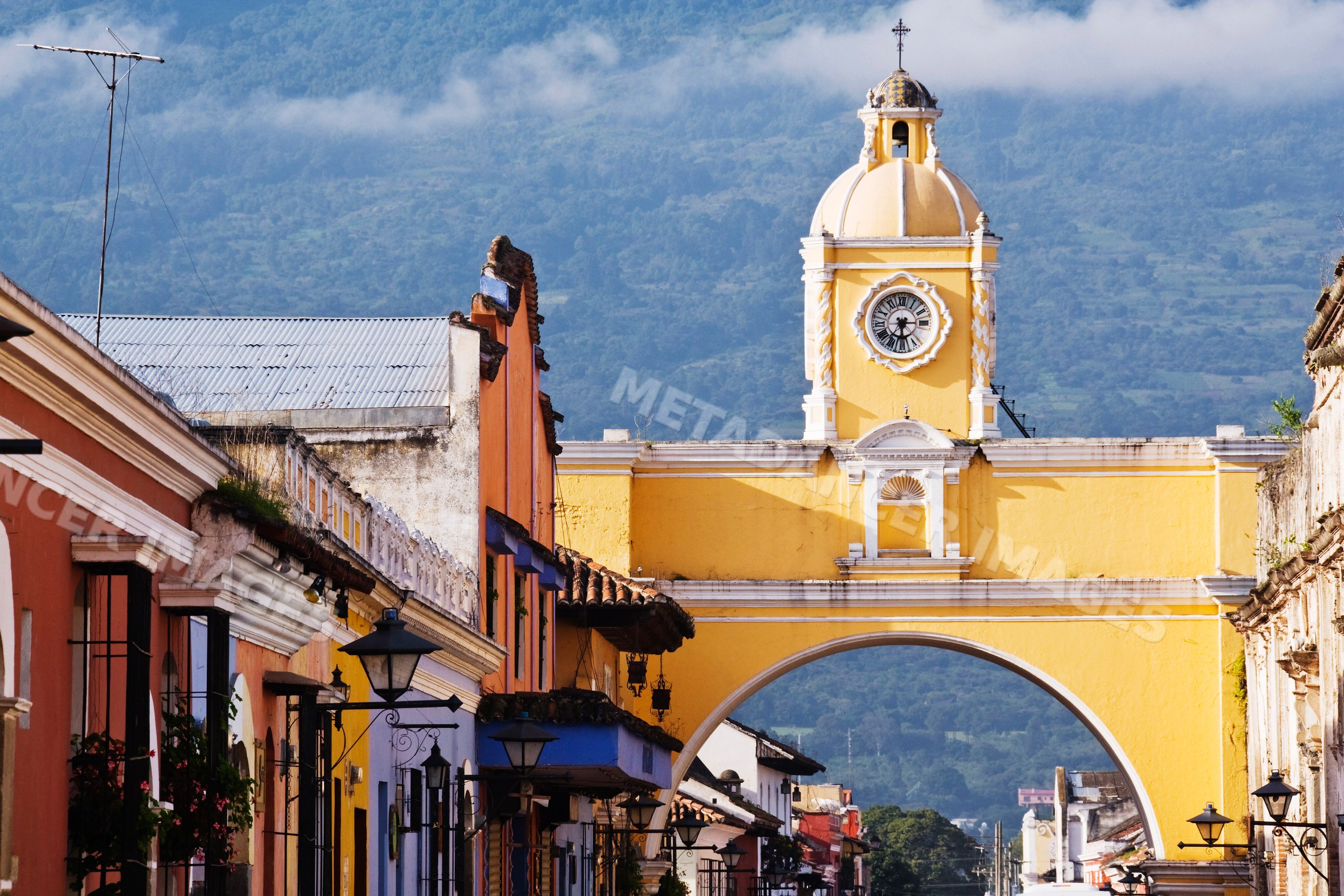 Clock tower and historic yellow arch guatemala street scene