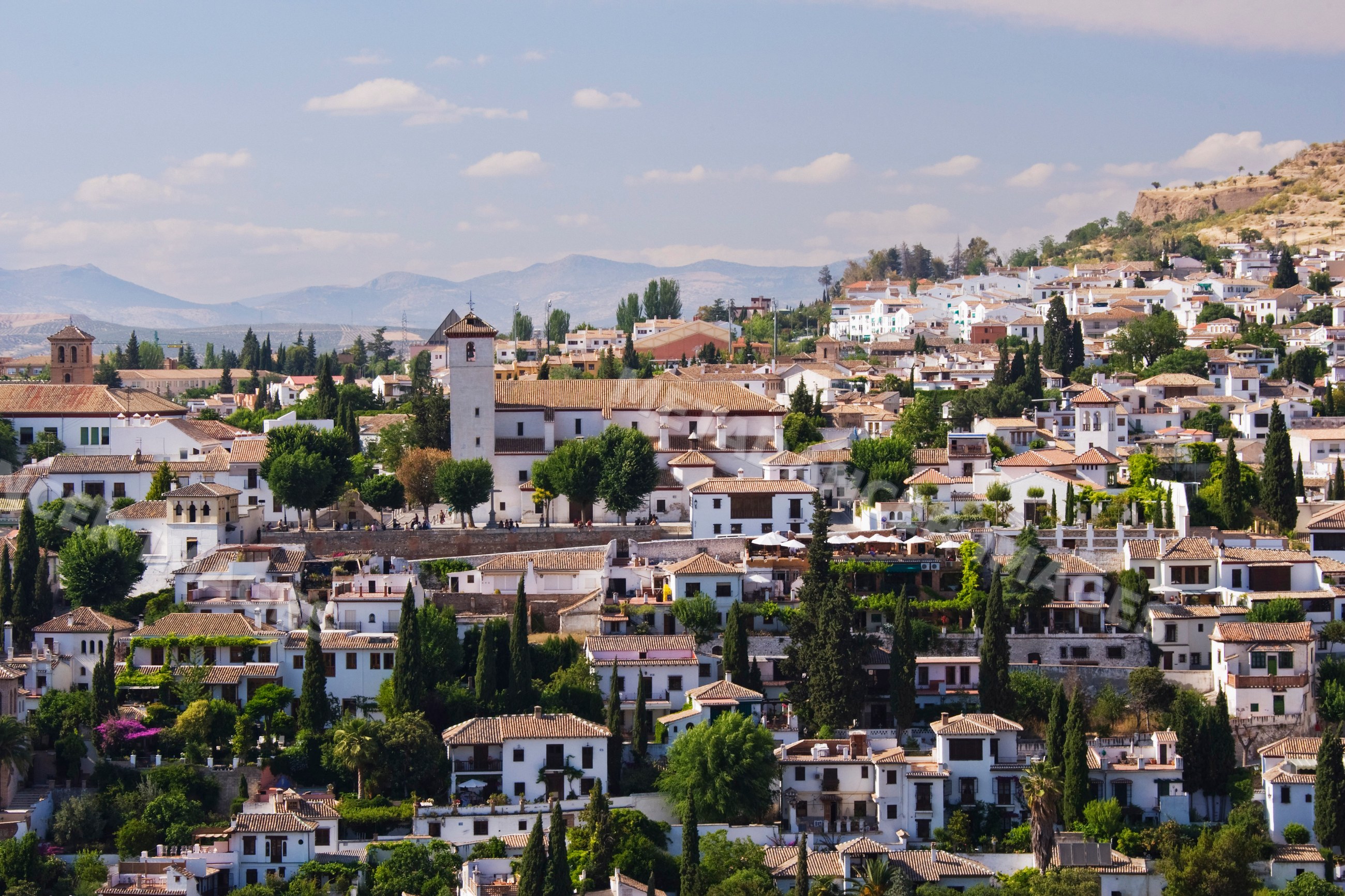 Mediterranean town with white houses and church tower, Spain