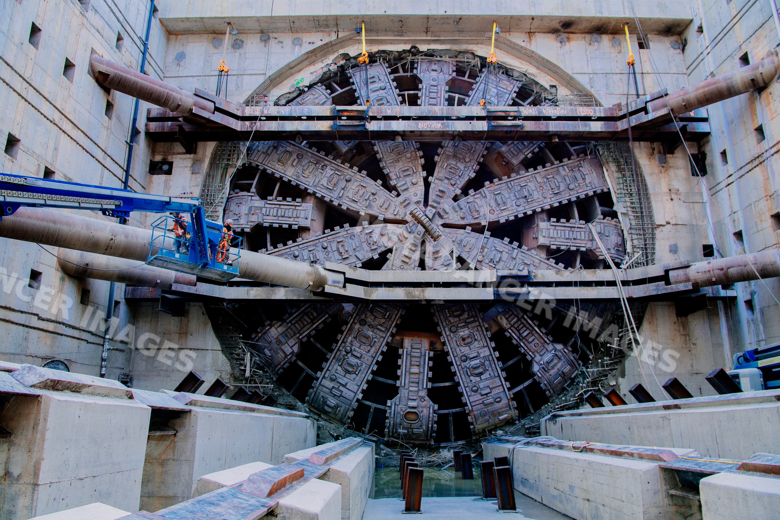 A large tunnel boring machine drills a tunnel at a construction site