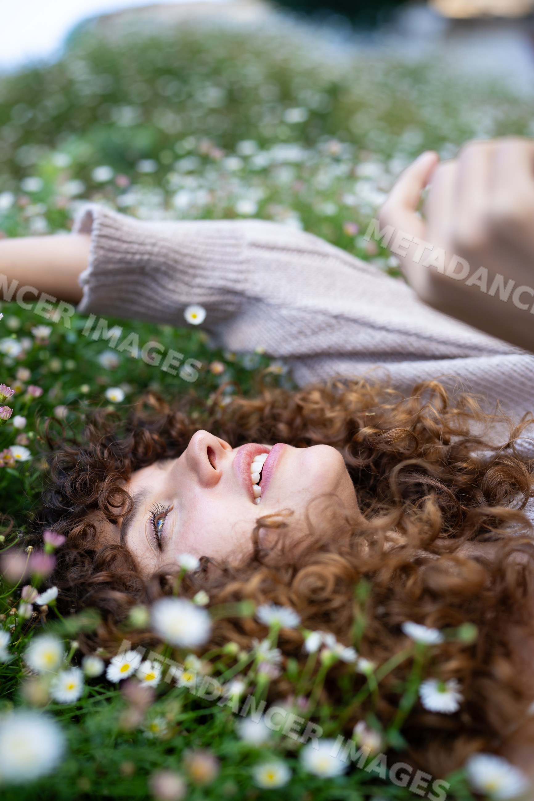 White woman with curly hair lies