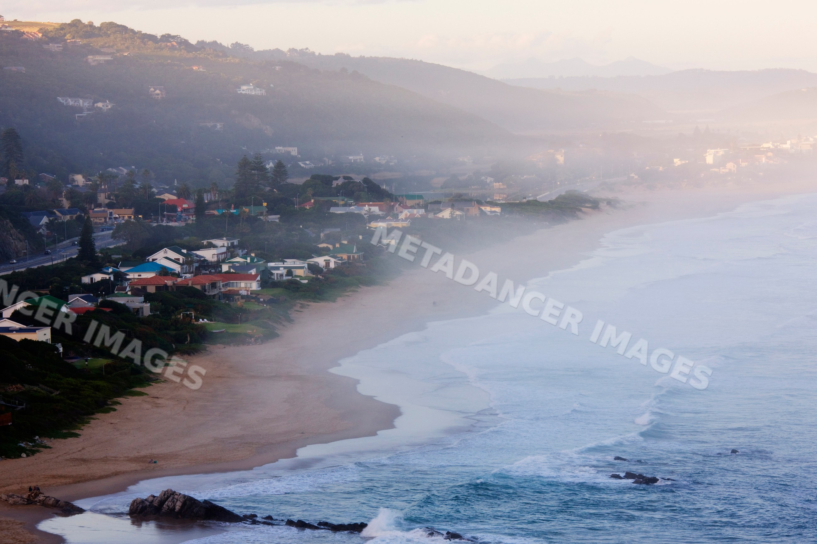 Ocean mist over hermanus beach at dusk, south africa