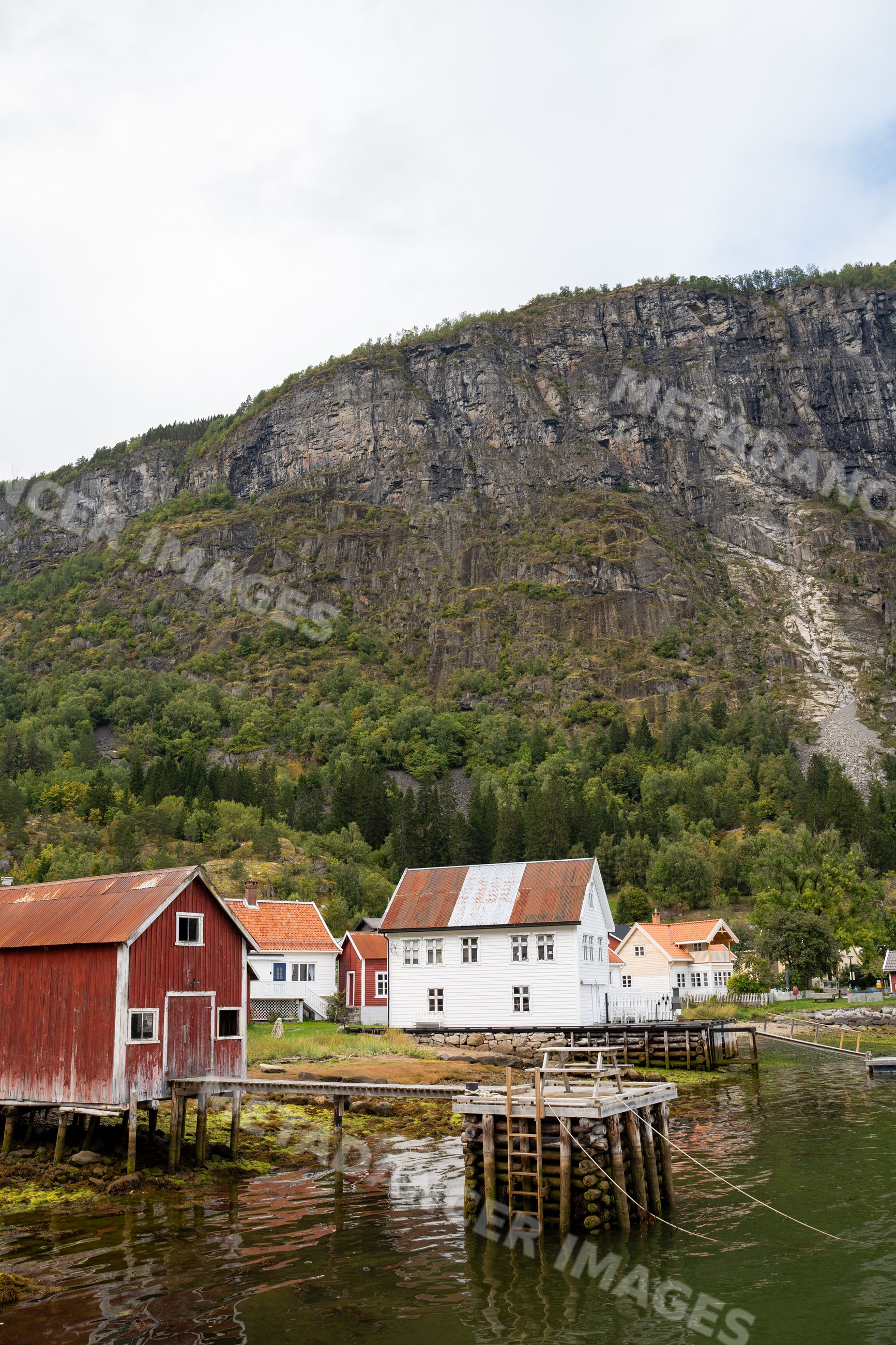 Norwegian Fjord village with rustic houses and docks in Luster, Norway