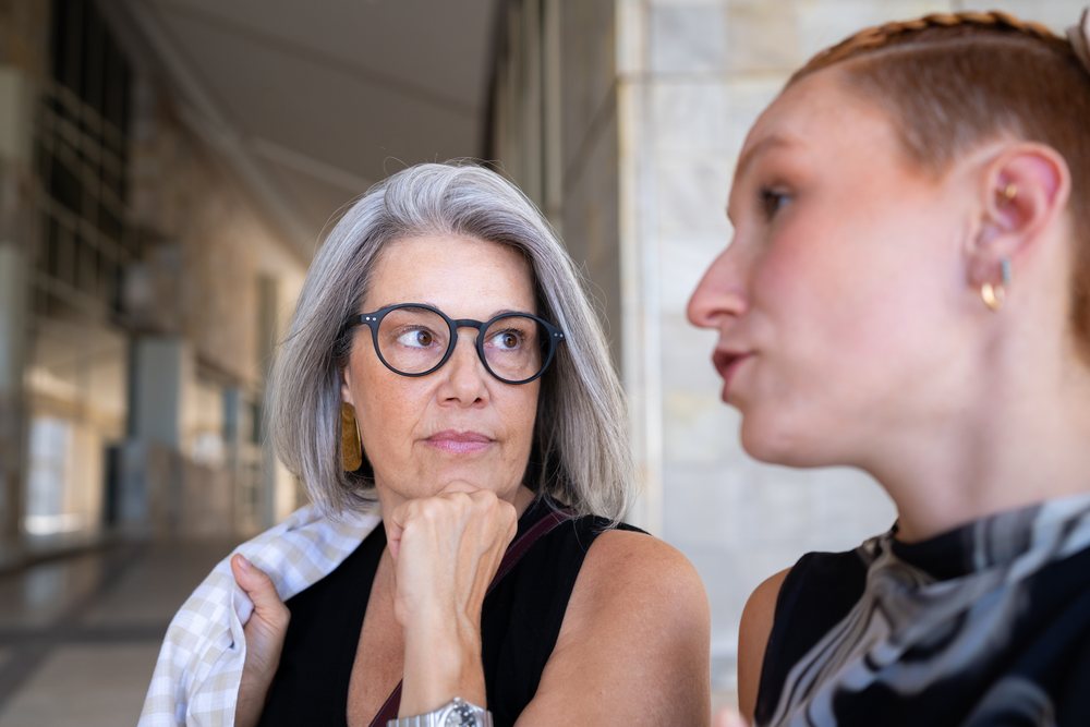 Two businesswomen engaged in conversation indoors in Spain
