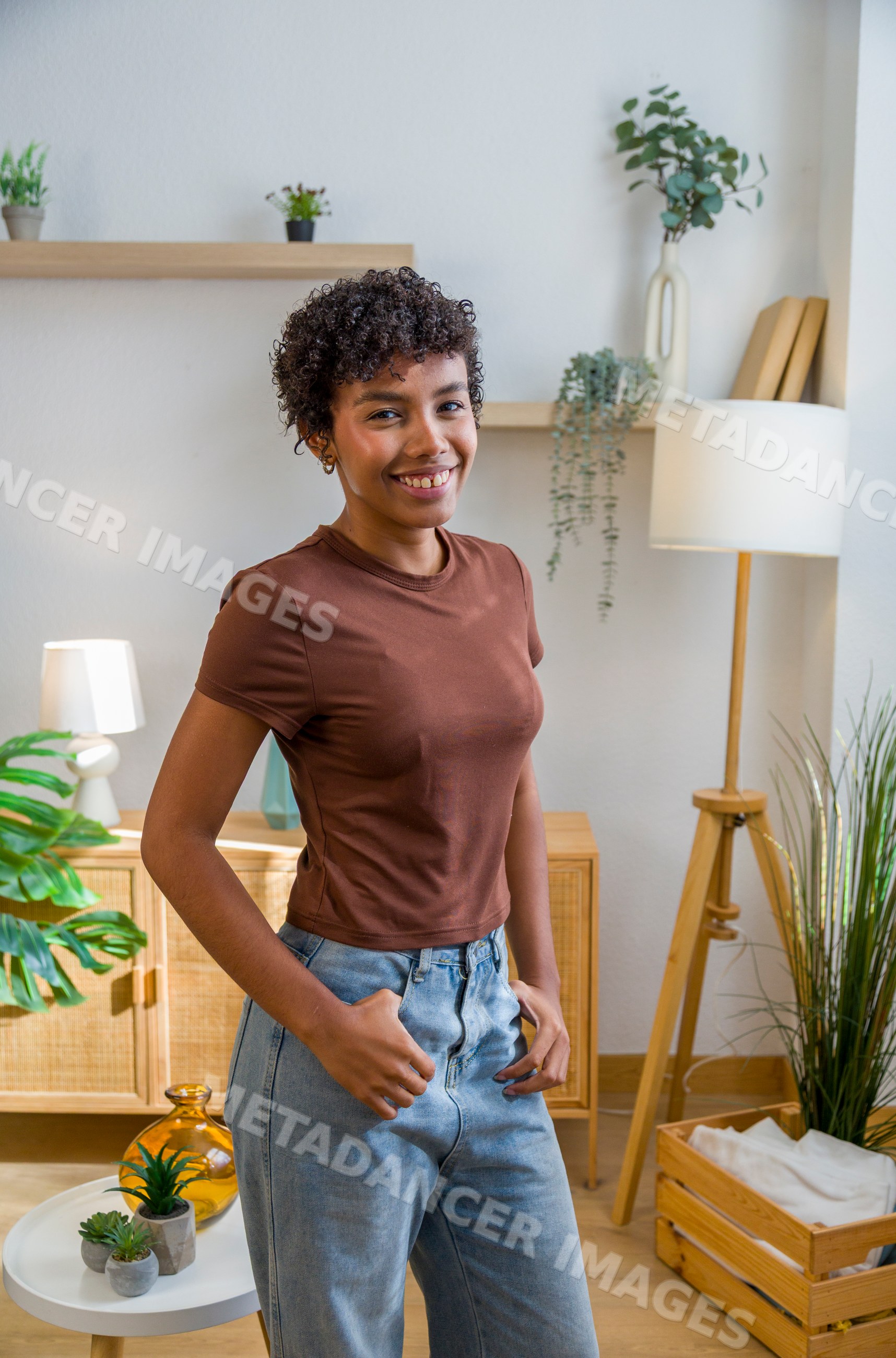 African American woman smiling and standing in modern home interior