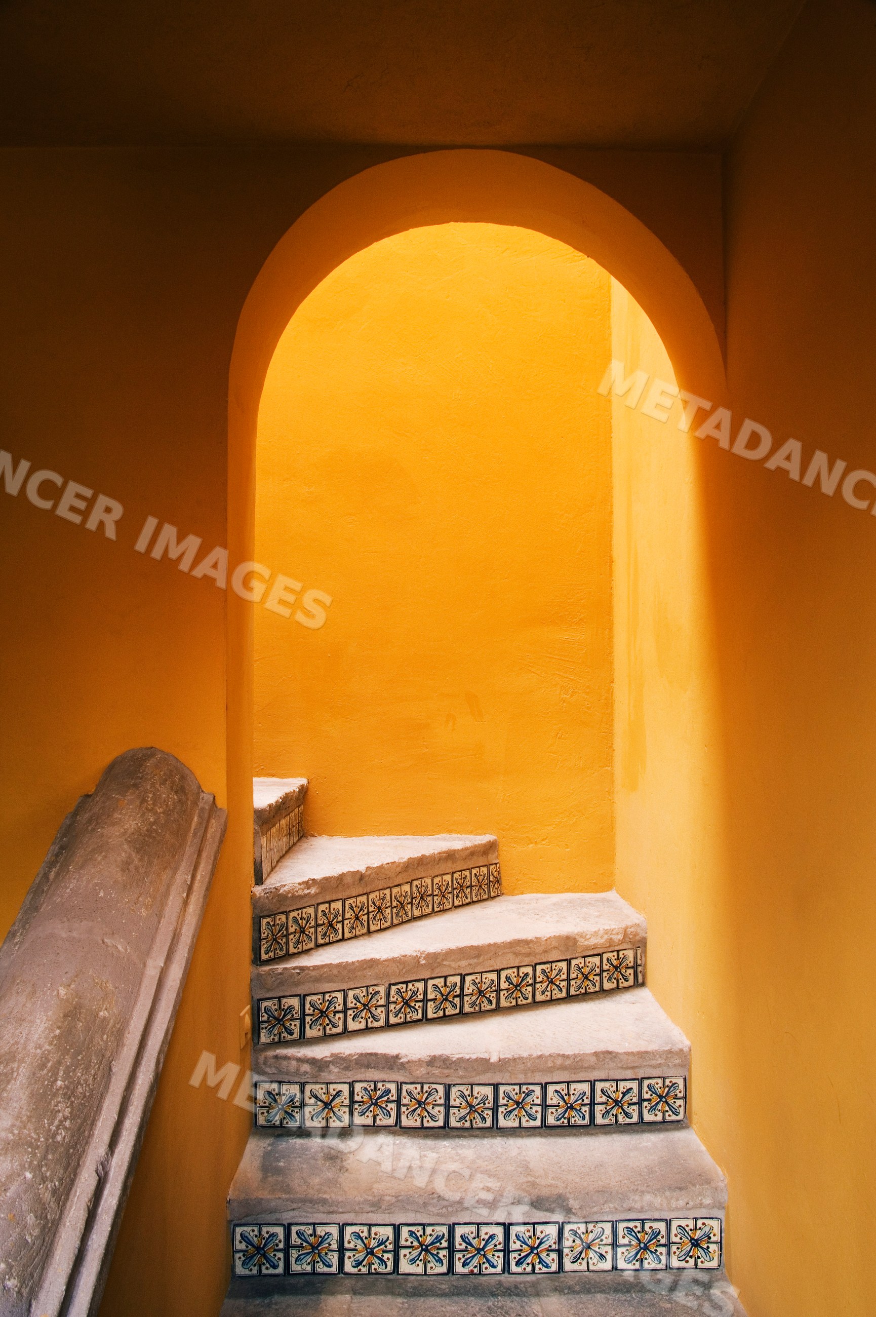 Mexican house stairway with decorative tile and arched doorway mexico