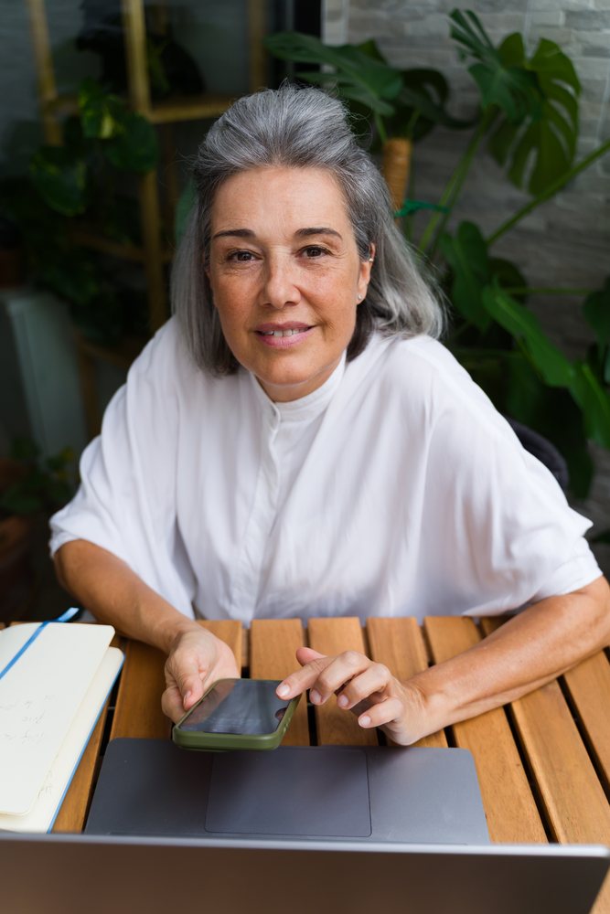 Mature white woman using smartphone