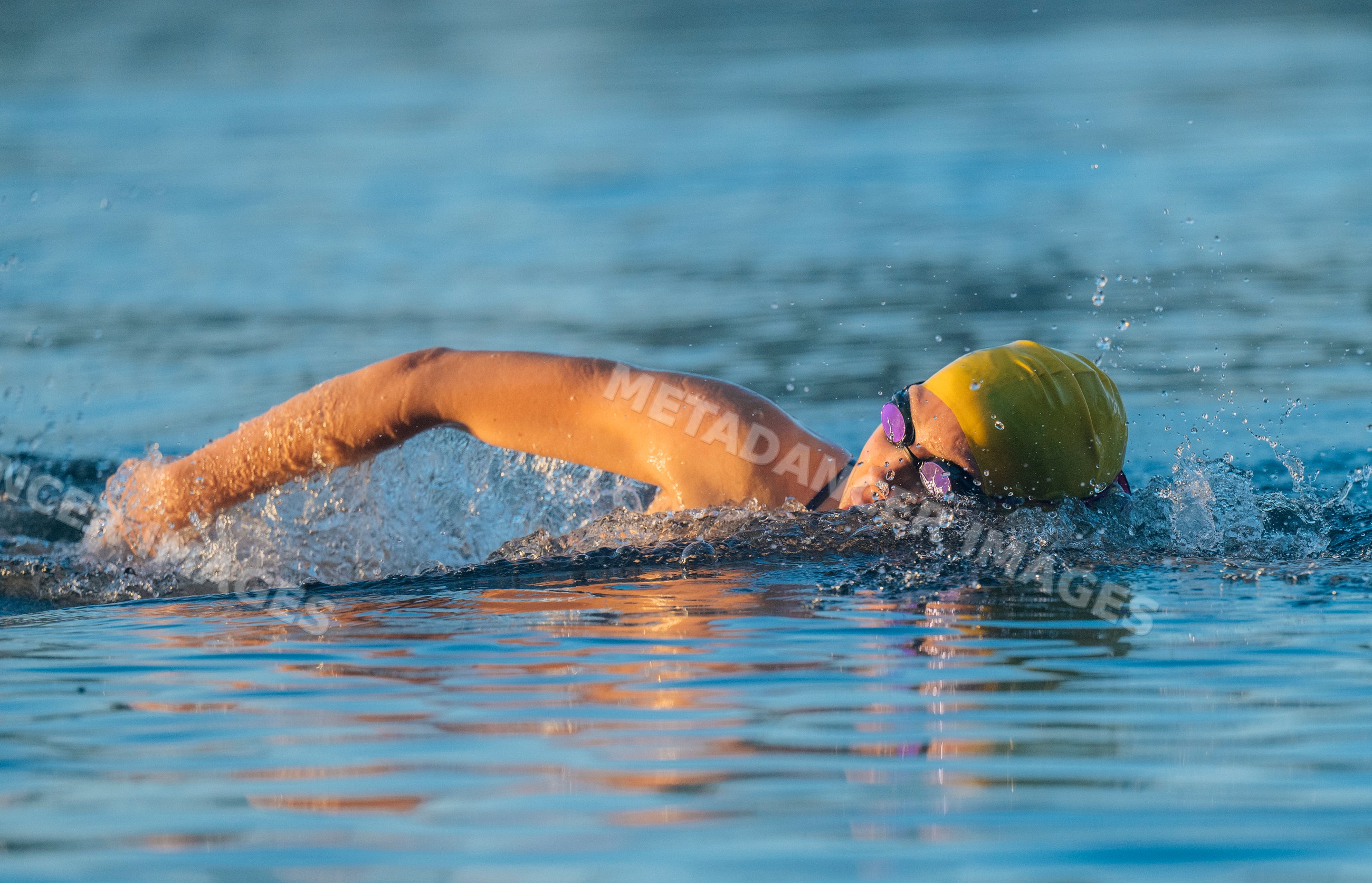 White swimmer performing freestyle stroke in open water USA