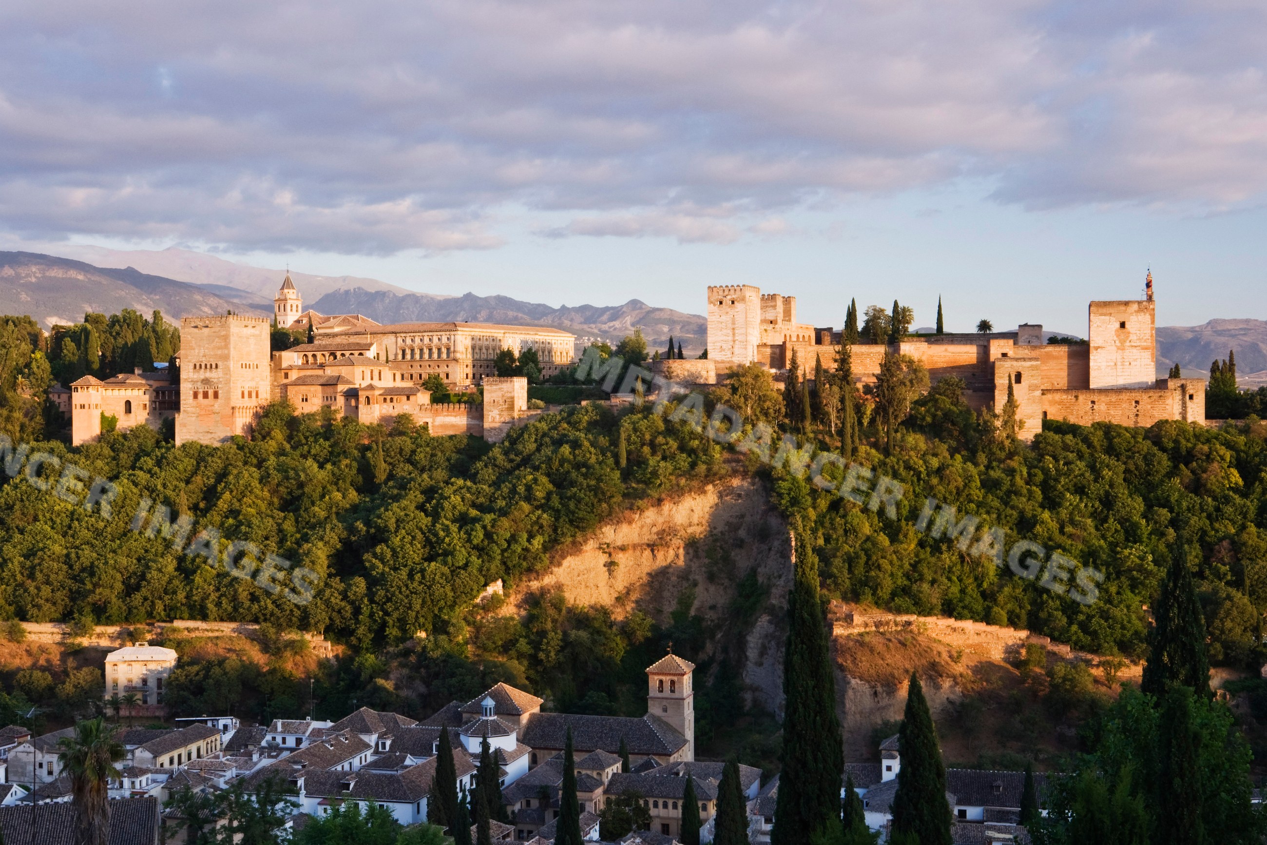 Alhambra castle fortress overlooking granada Spain at sunset