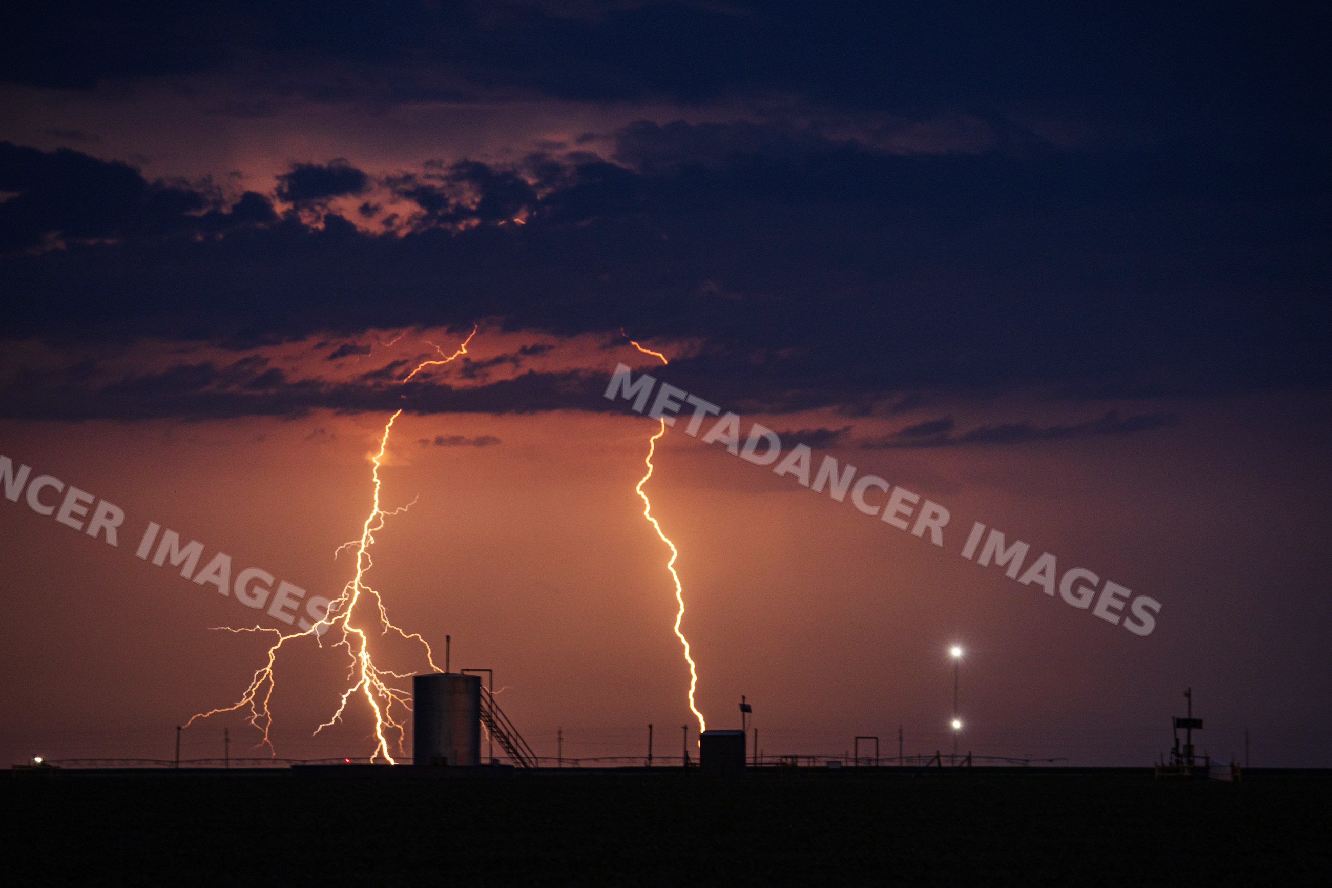 Lightning striking over Farm Fields at night in perryton texas