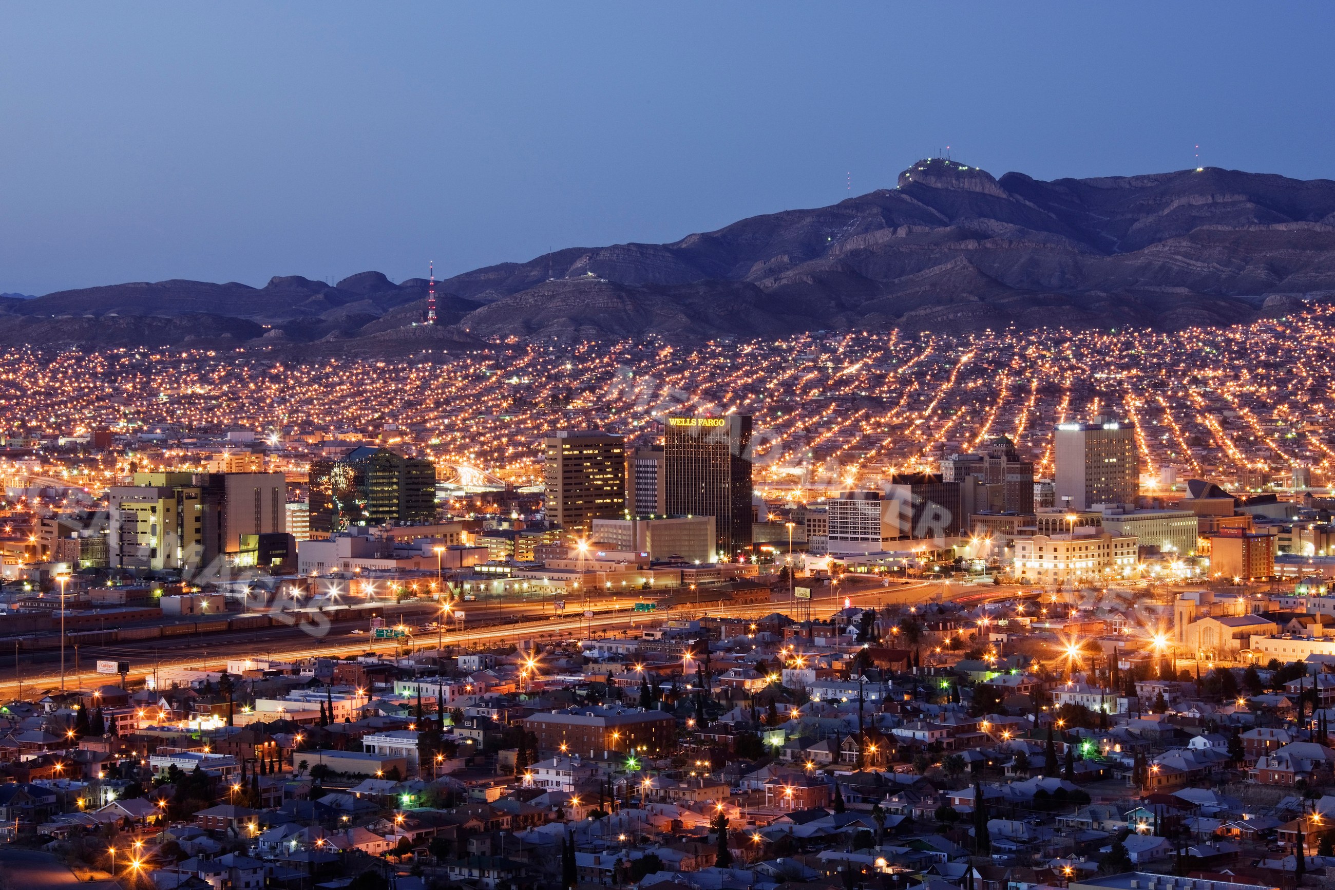 El paso cityscape illuminated at dusk with mountain backdrop