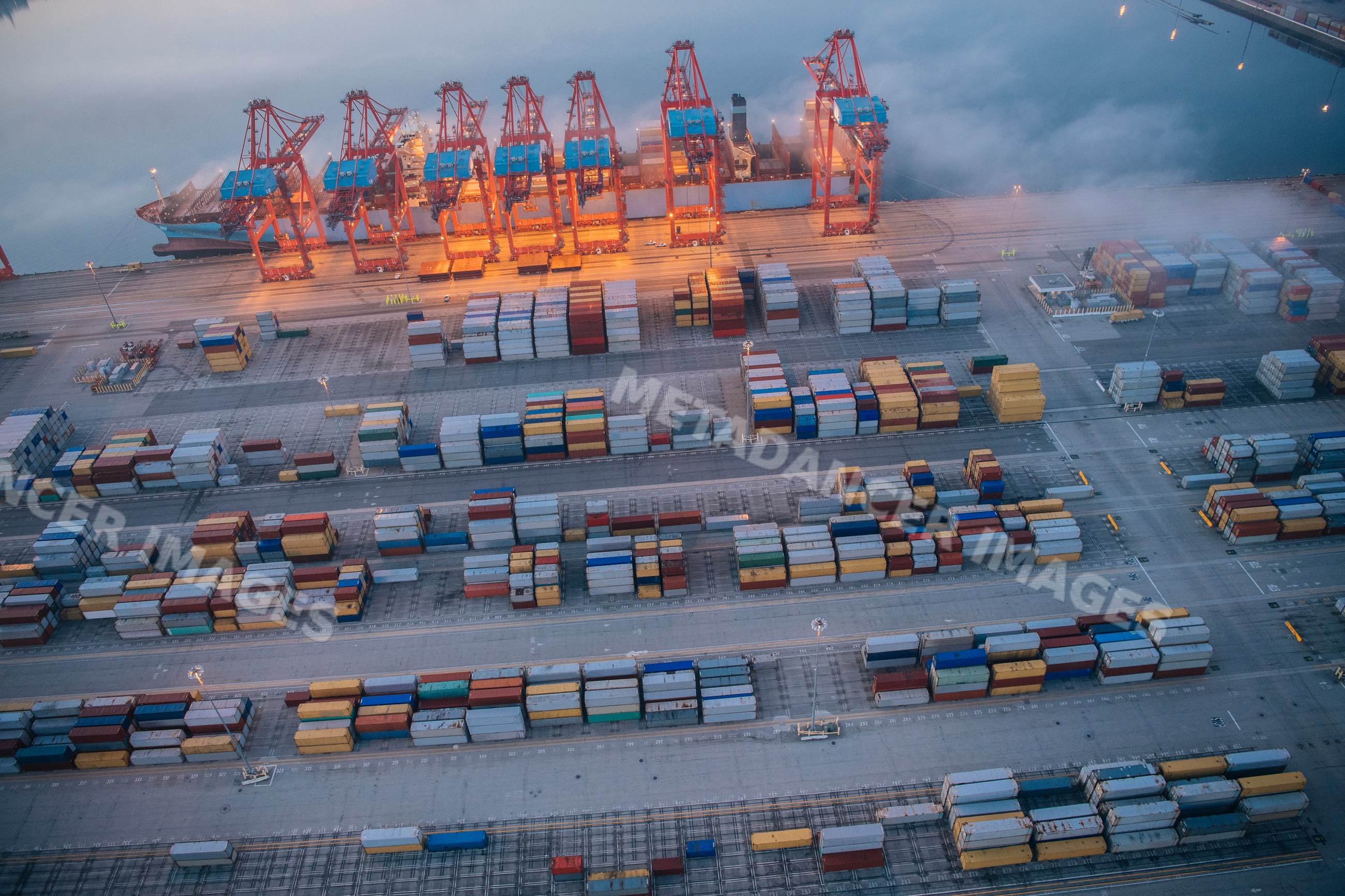 Aerial view of container cranes and shipping containers at a busy port