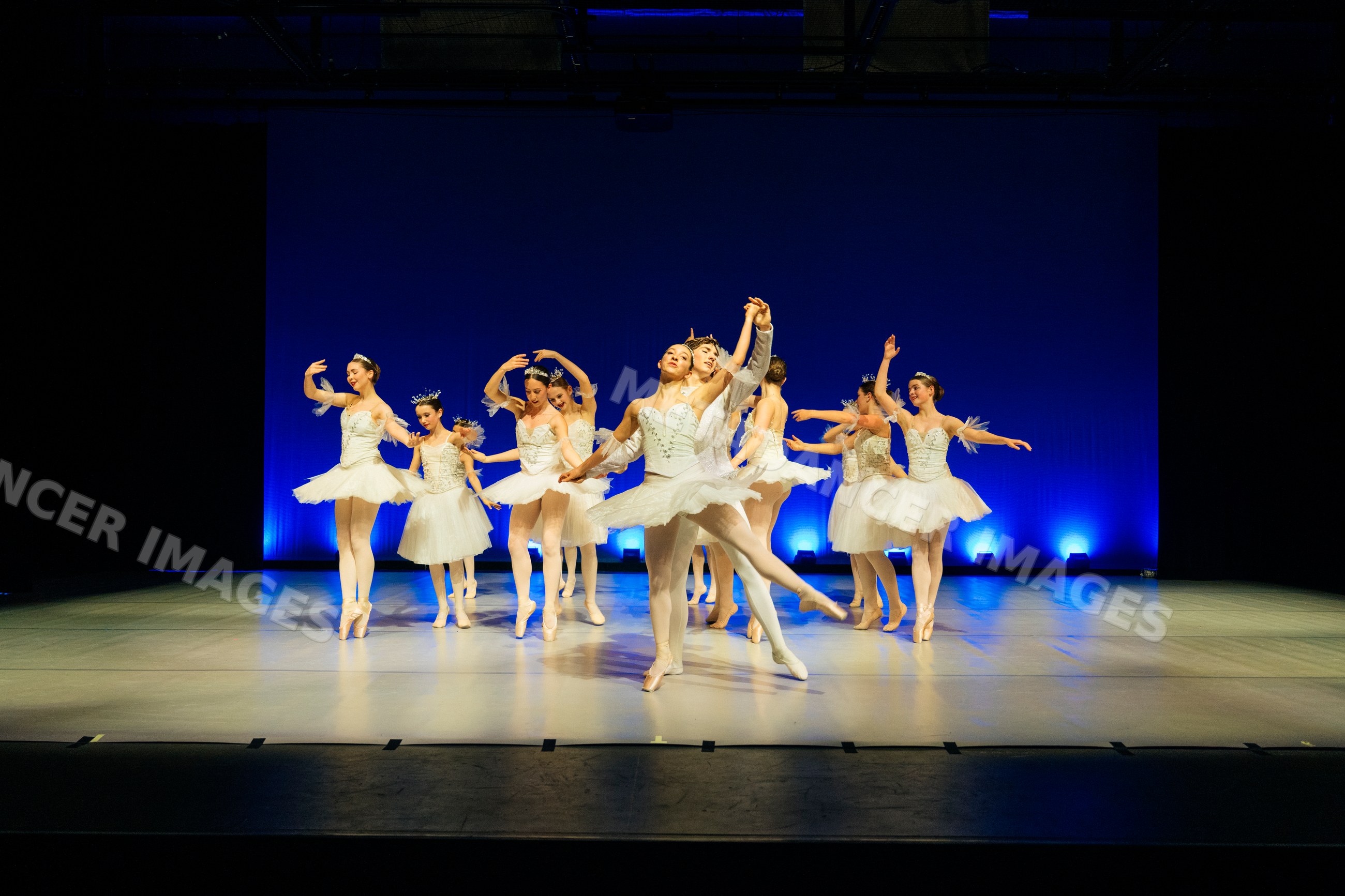 Ballet dancers perform a classical dance on stage