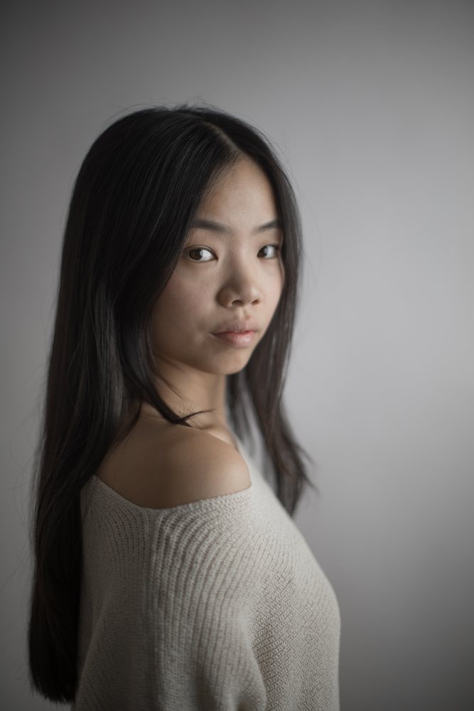 Portrait of young asian Southeast Asian woman in off-shoulder sweater