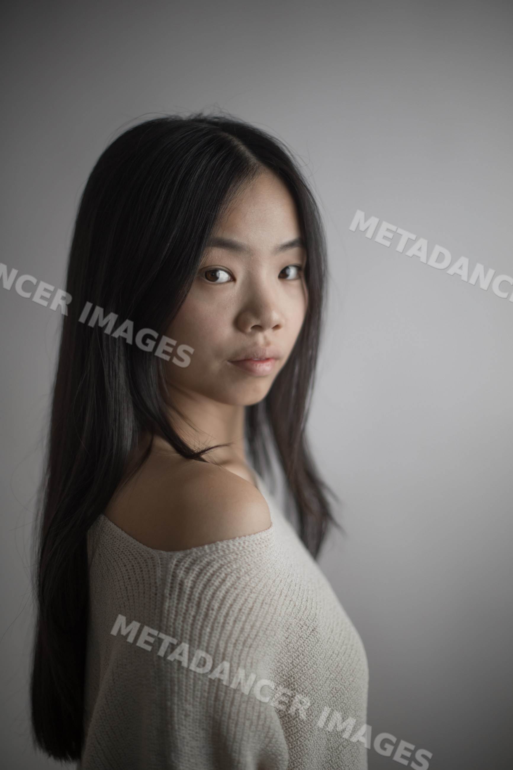 Portrait of young asian Southeast Asian woman in off-shoulder sweater