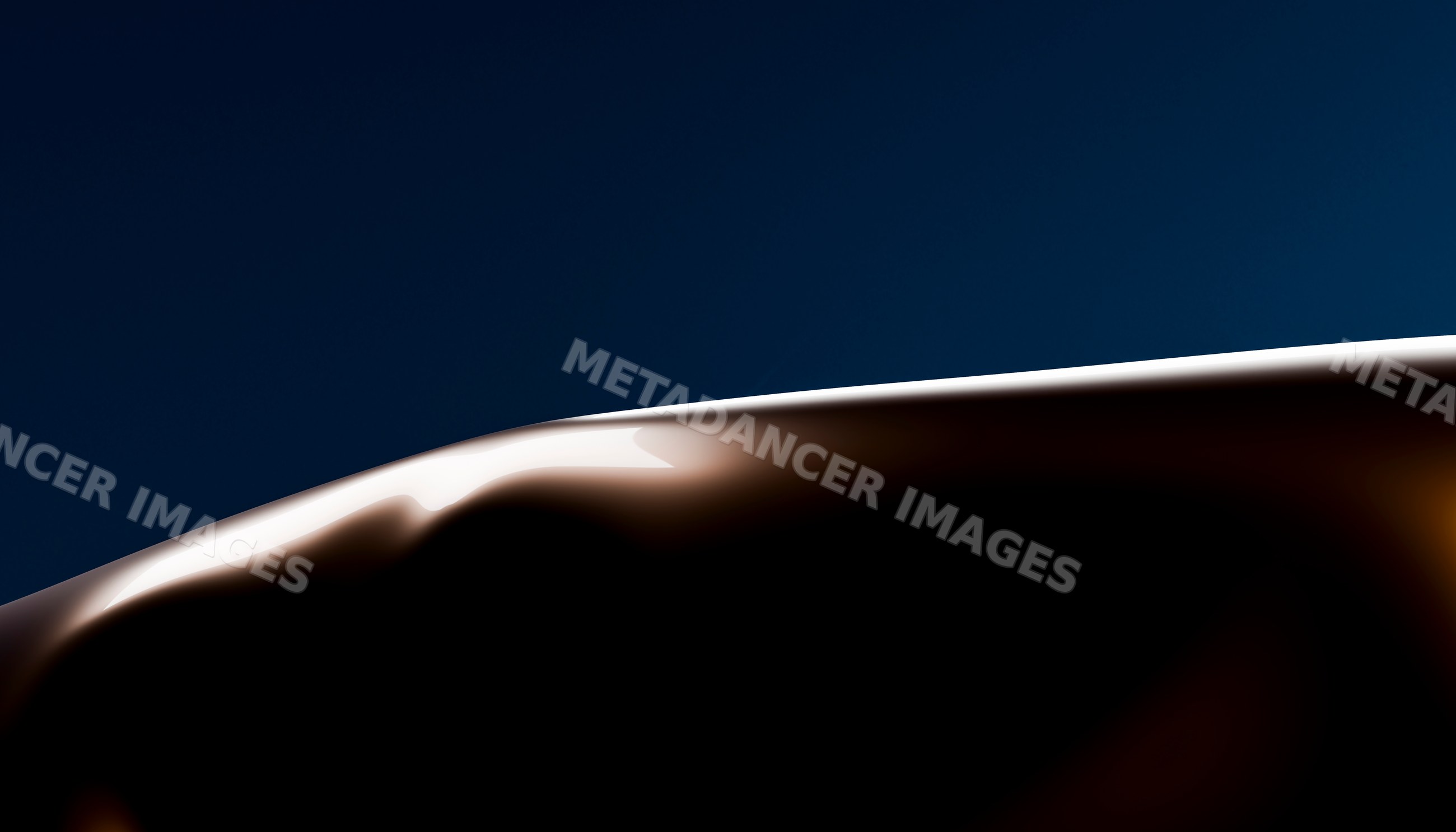 Close-up of smooth melted dark chocolate with glossy surface