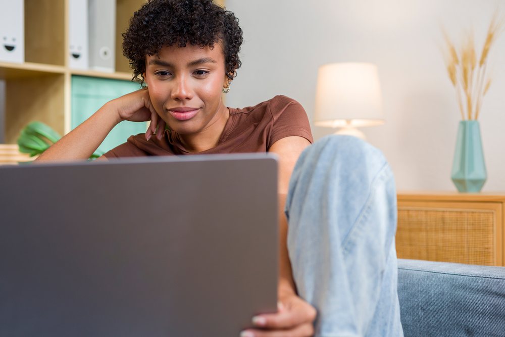 Young African American woman using laptop