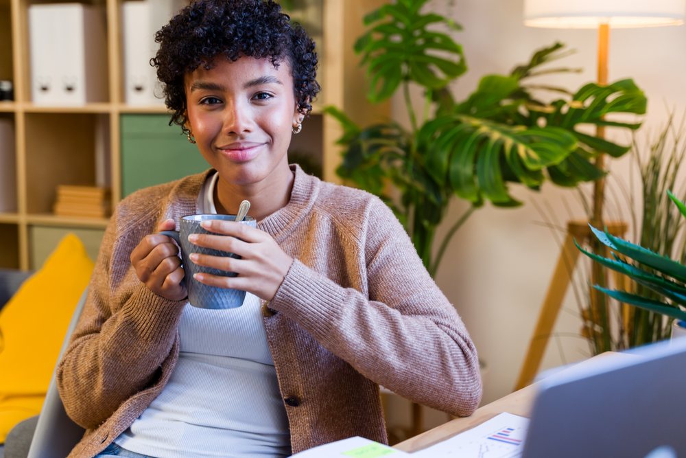 African American woman smiling and holding a mug
