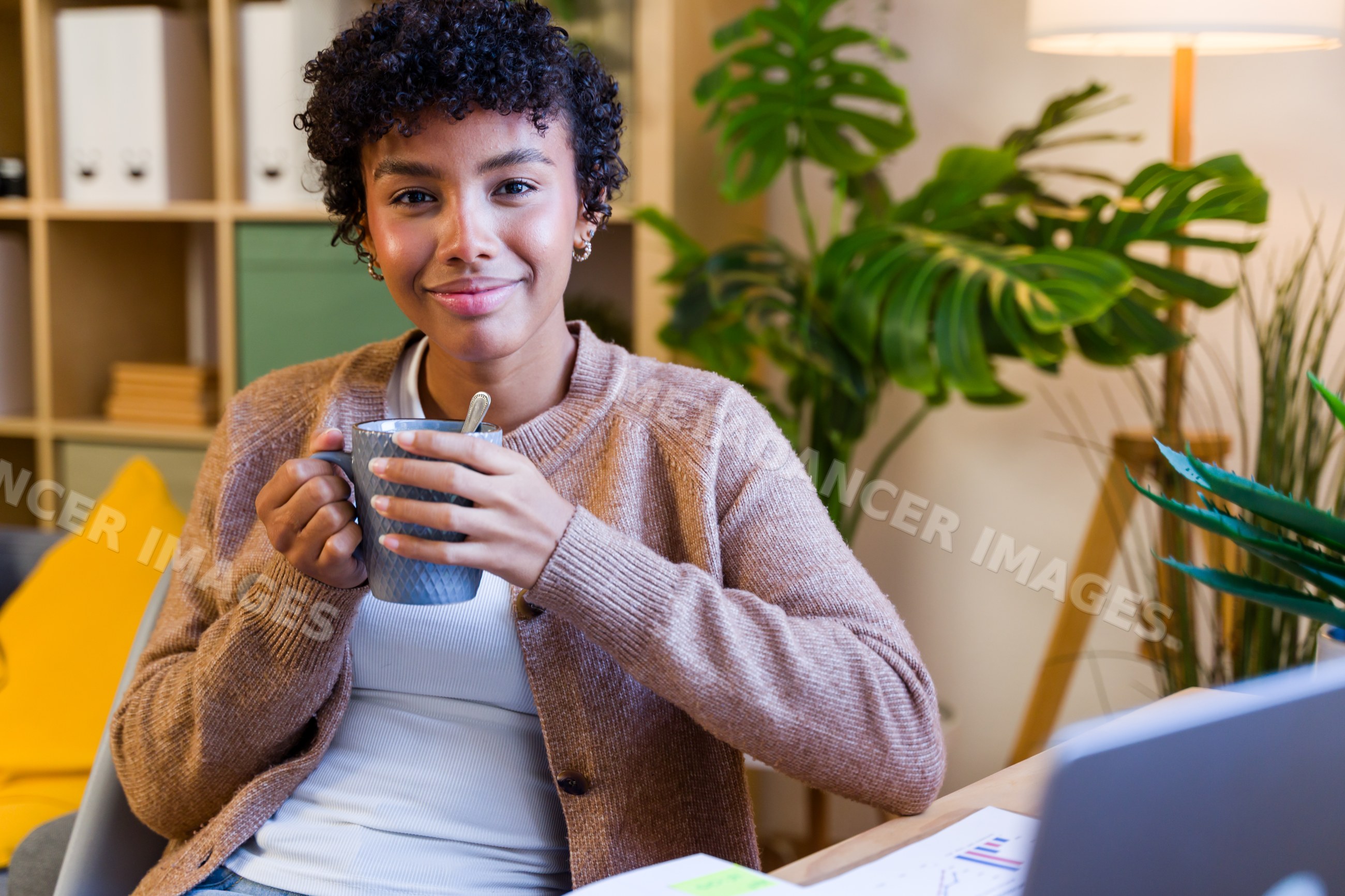 African American woman smiling and holding a mug