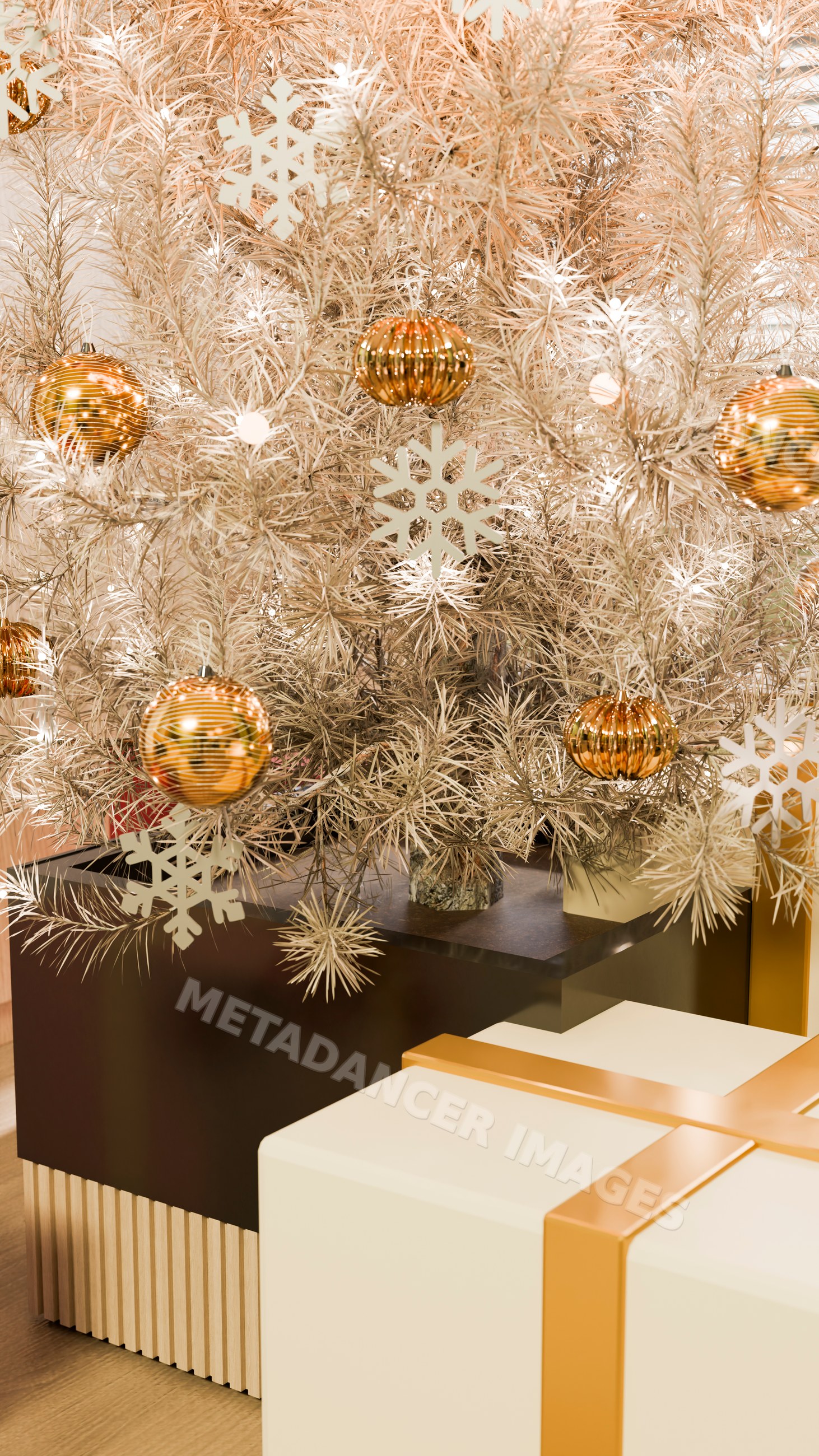 Christmas tree decorated with gold ornaments and a wrapped gift box