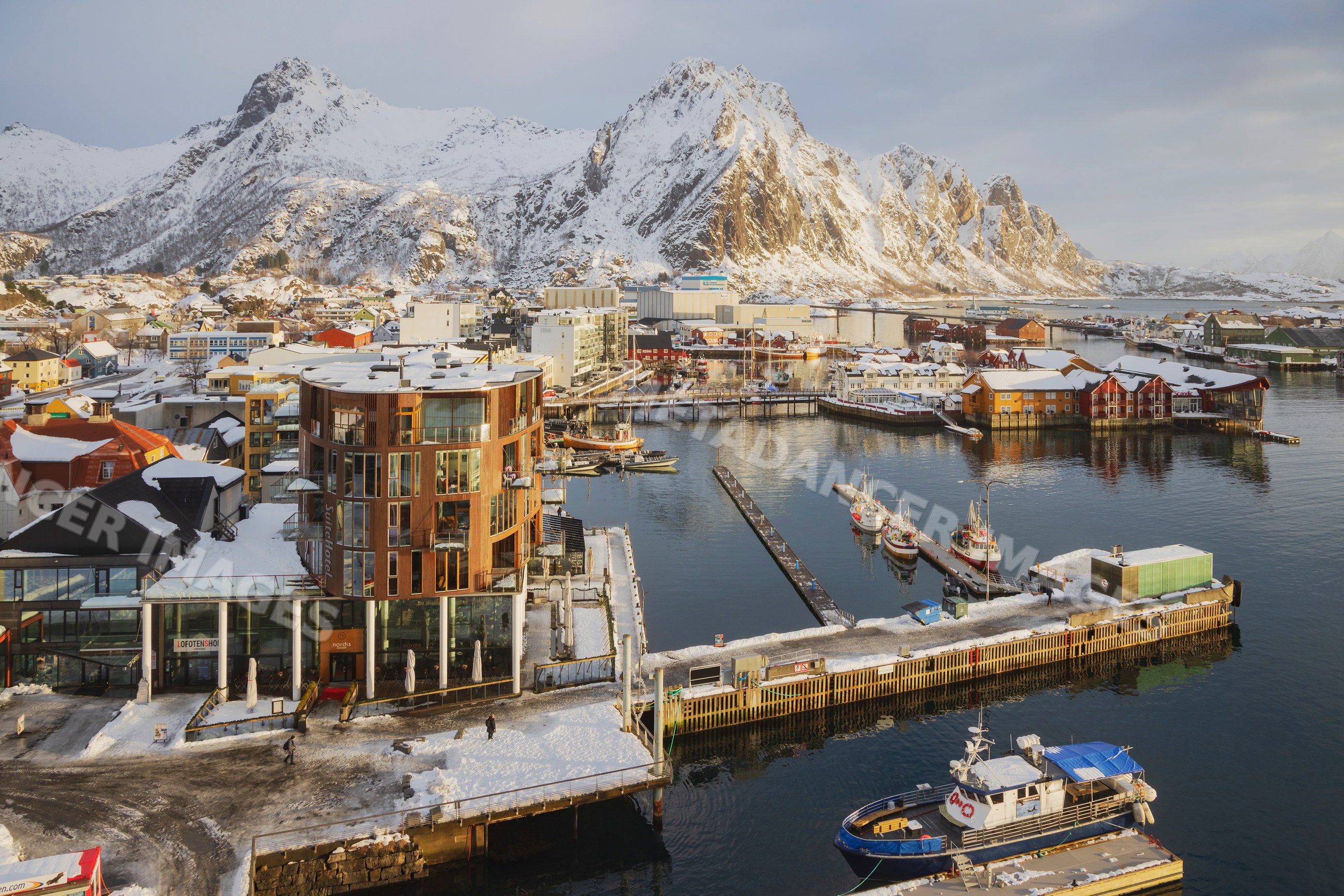 Port and snow-covered mountains at Sunrise in svolvaer, Lofoten