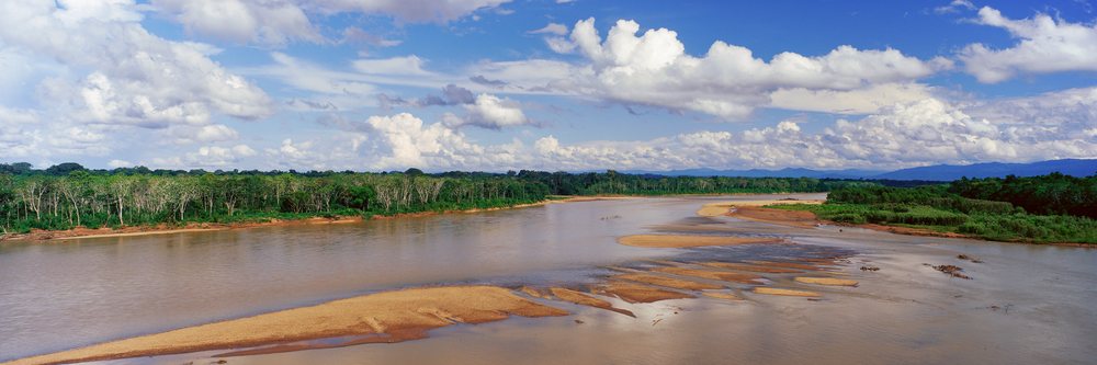 Rio tambopata flowing through tropical forest with sandbars in peru