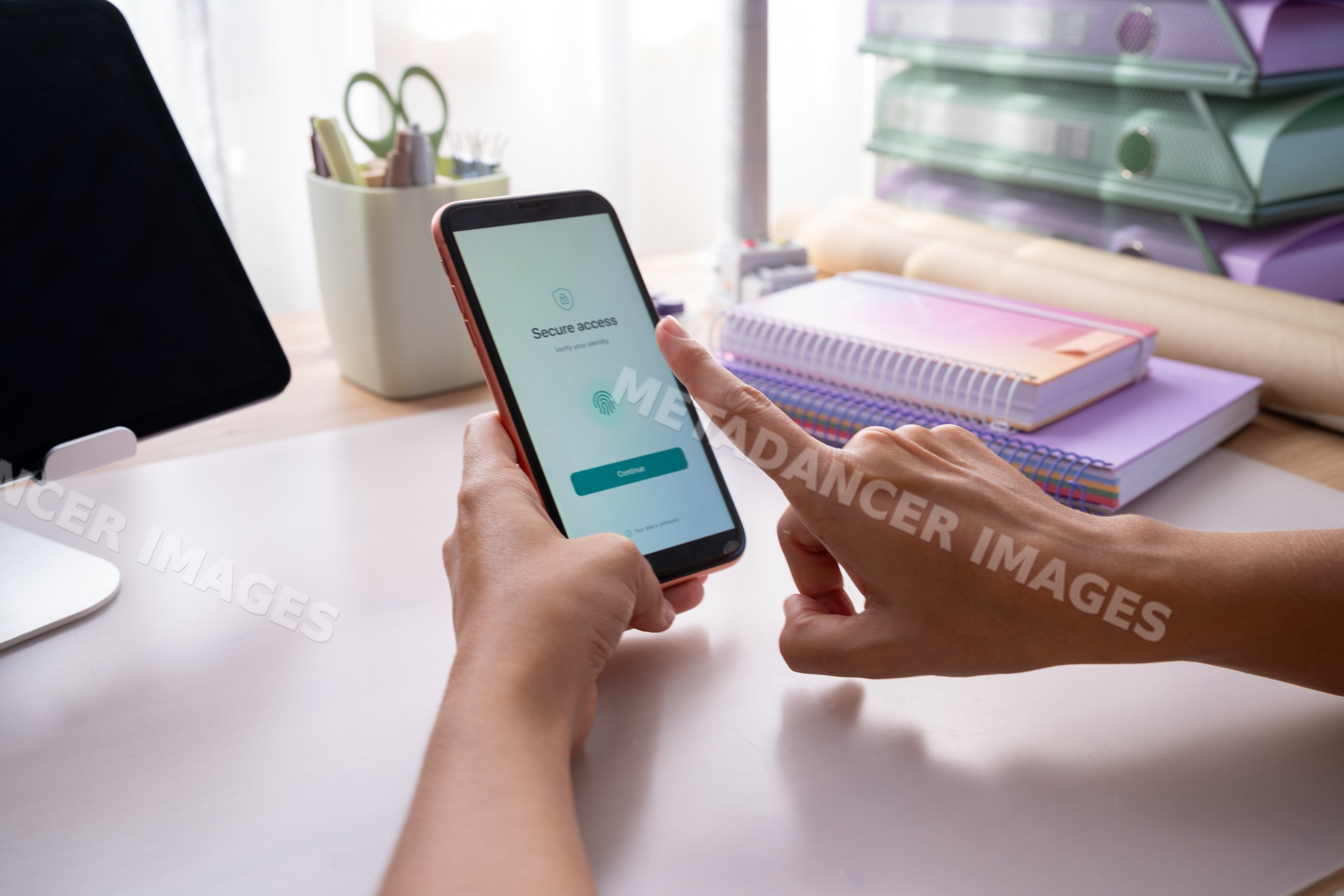 Hand using fingerprint authentication on smartphone with secure access